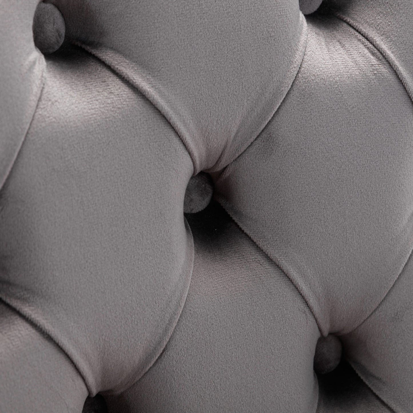 Closeup of gray velvet tufted upholstery