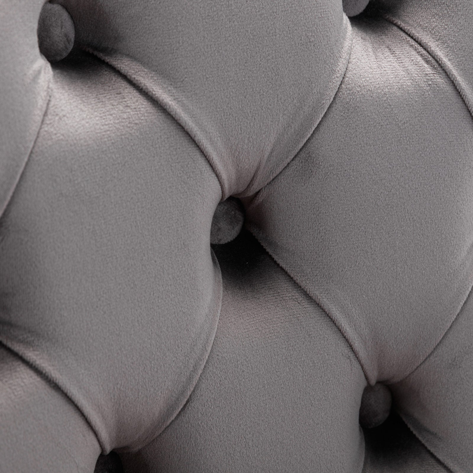 Closeup of gray velvet tufted upholstery
