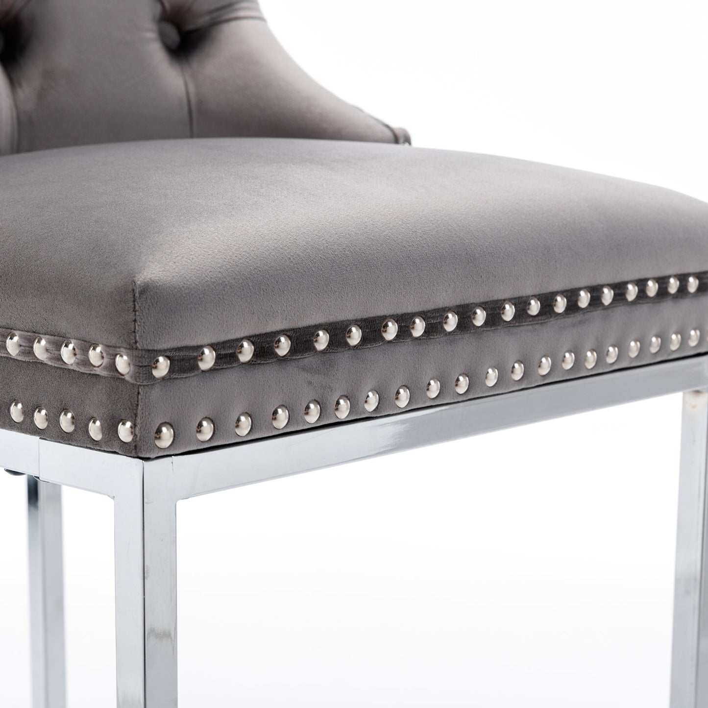 Grey velvet tufted bar stool with polished chrome legs and decorative nailhead trim