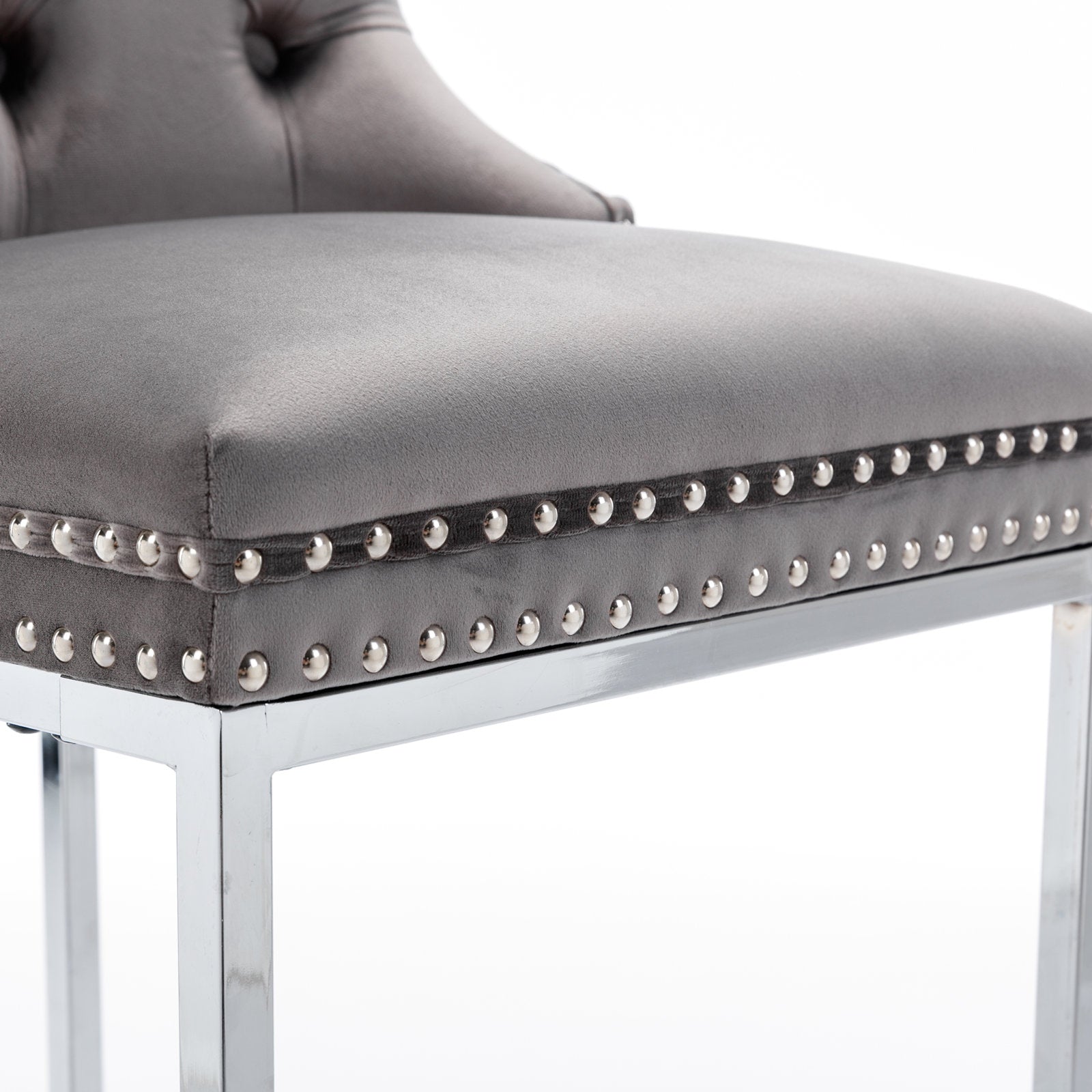 Grey velvet tufted bar stool with polished chrome legs and decorative nailhead trim