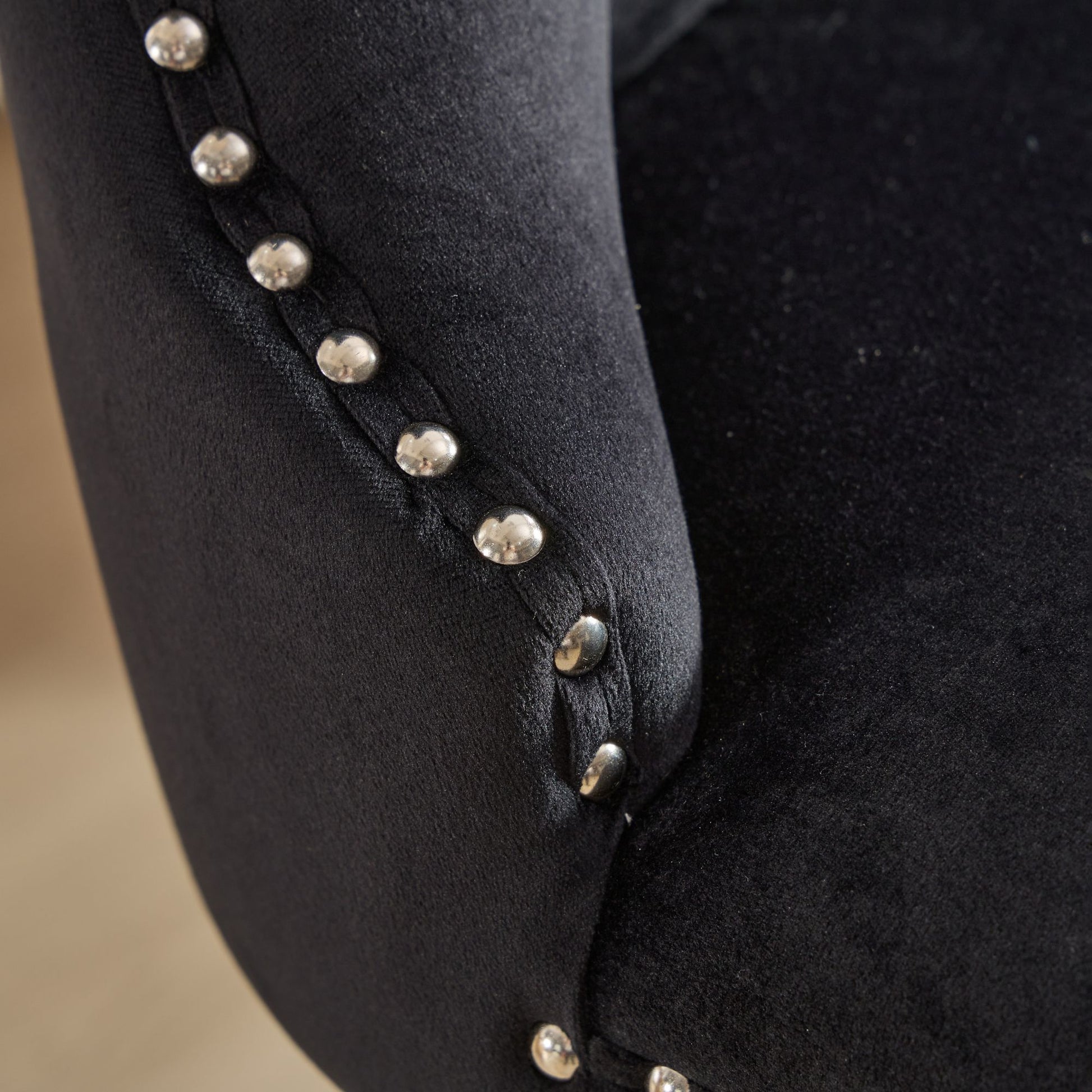 Black velvet armchair detail with silver nailhead trim