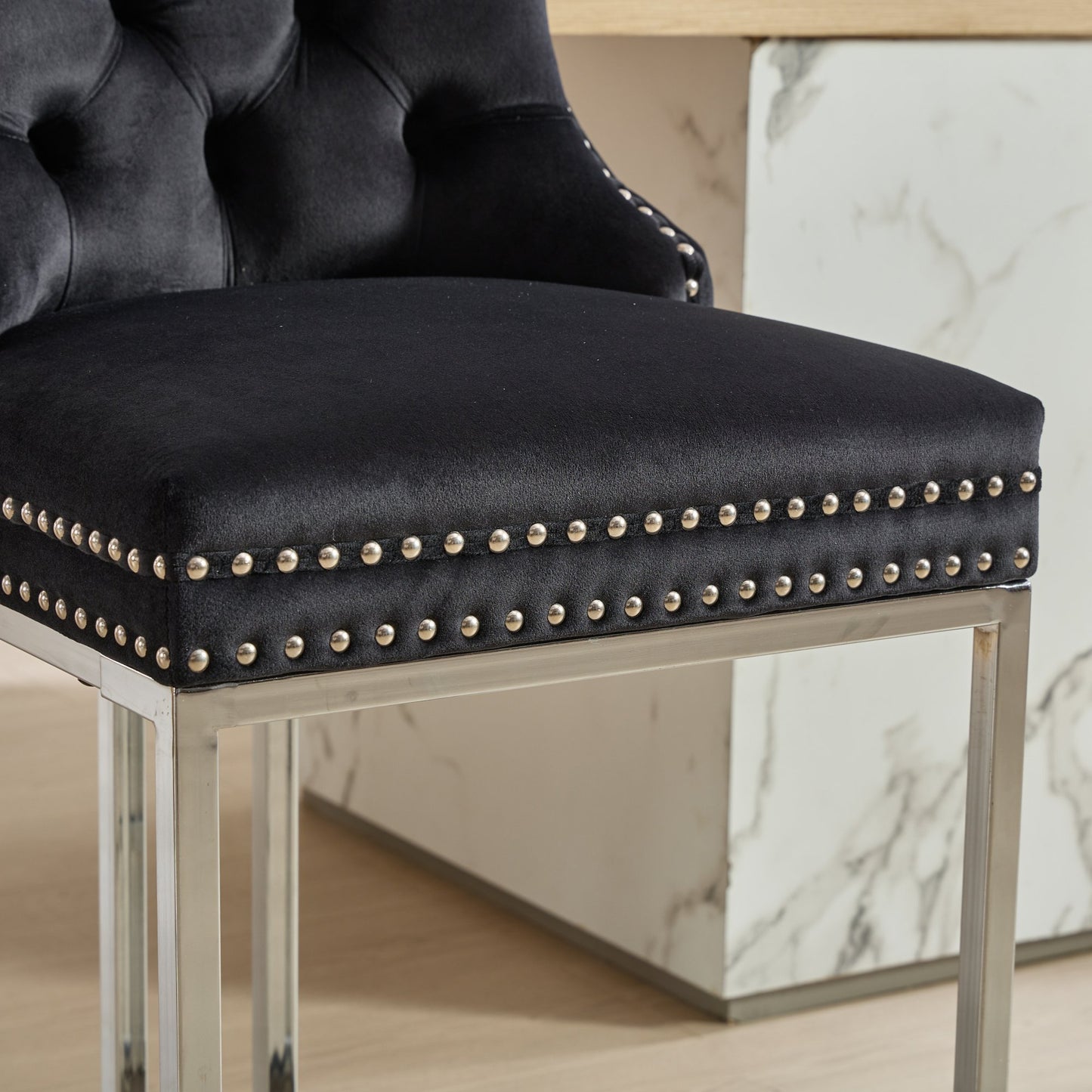 Black velvet bar stool with tufted back and silver nailhead trim