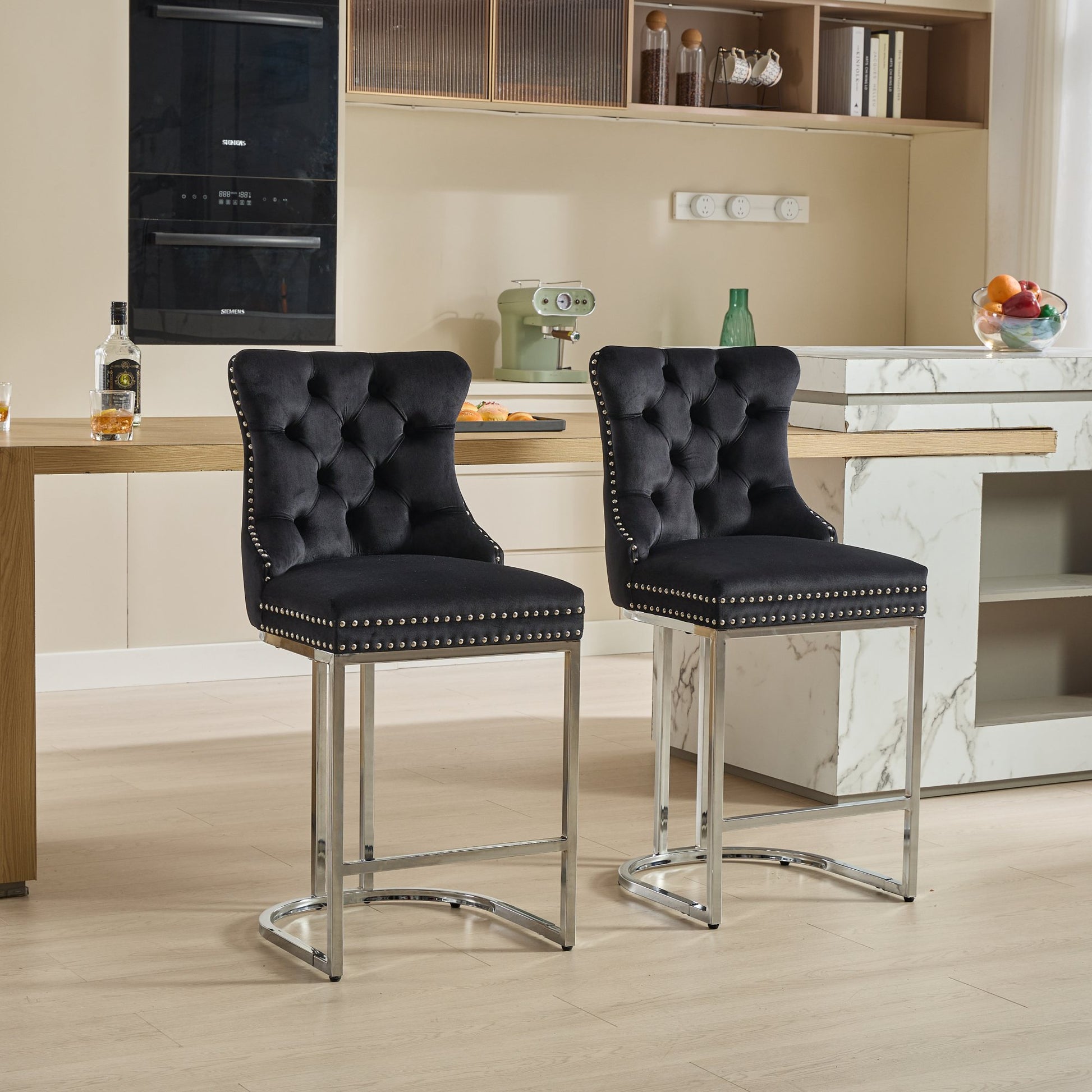 Black velvet tufted bar stool with silver nailhead trim and chrome legs