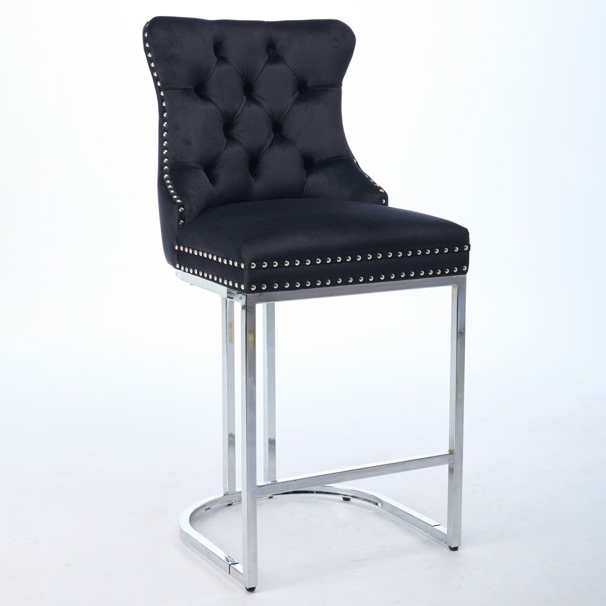 Black velvet tufted bar stool with silver nailhead trim and chrome legs