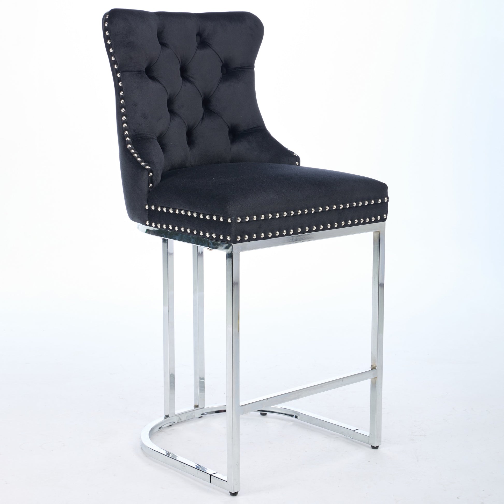 Black velvet tufted bar stool with silver nailhead trim and chrome legs