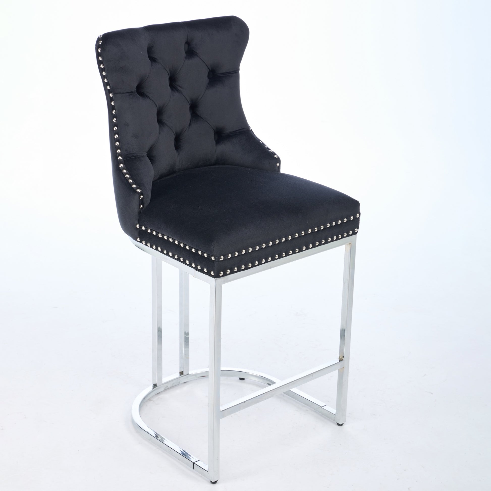 Black velvet tufted bar stool with silver nailhead trim and chrome base
