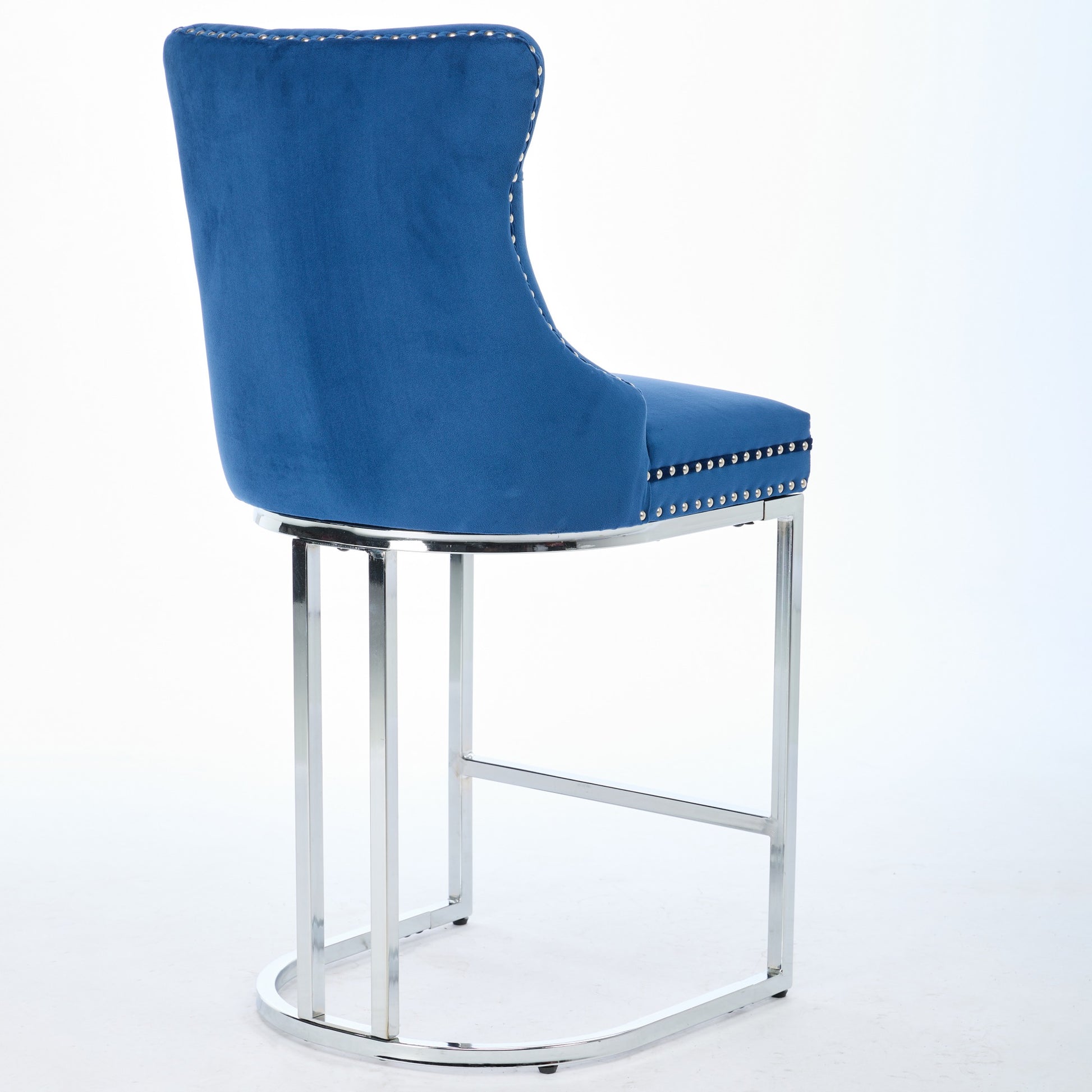 Tufted blue velvet bar stool with polished chrome base and studded trim