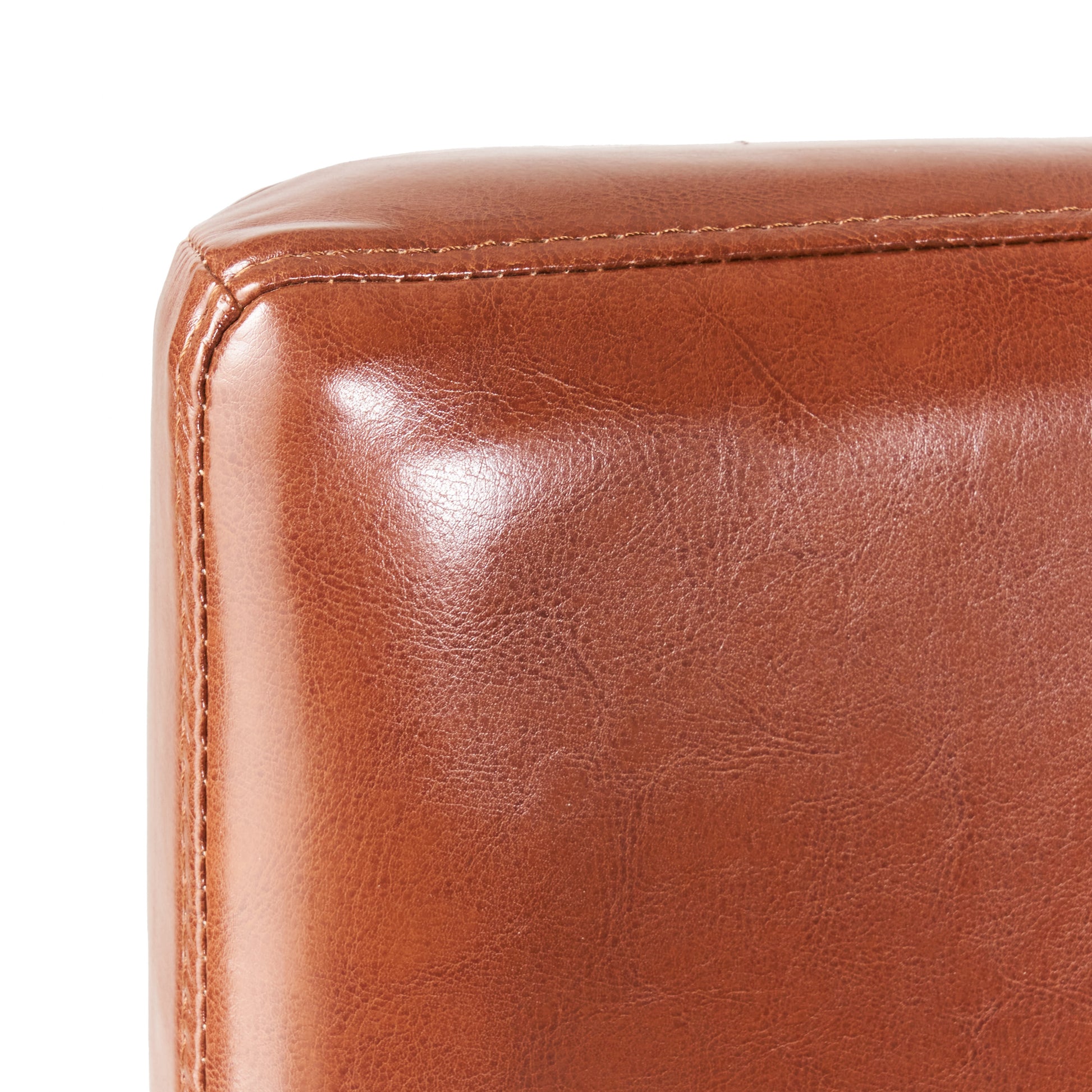 Closeup of rich brown faux leather texture with subtle stitching detail