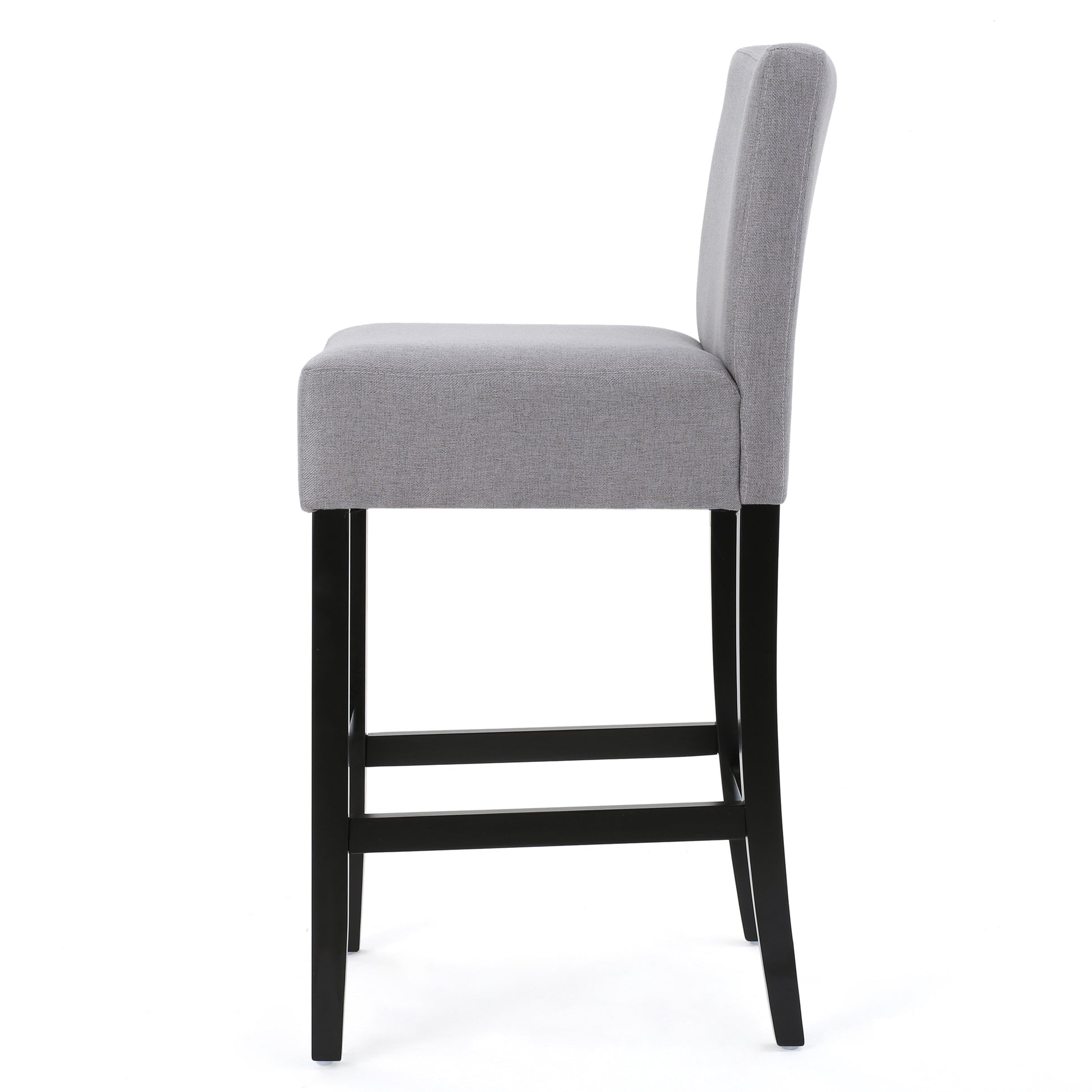 Side view of a grey upholstered bar stool with black wooden legs