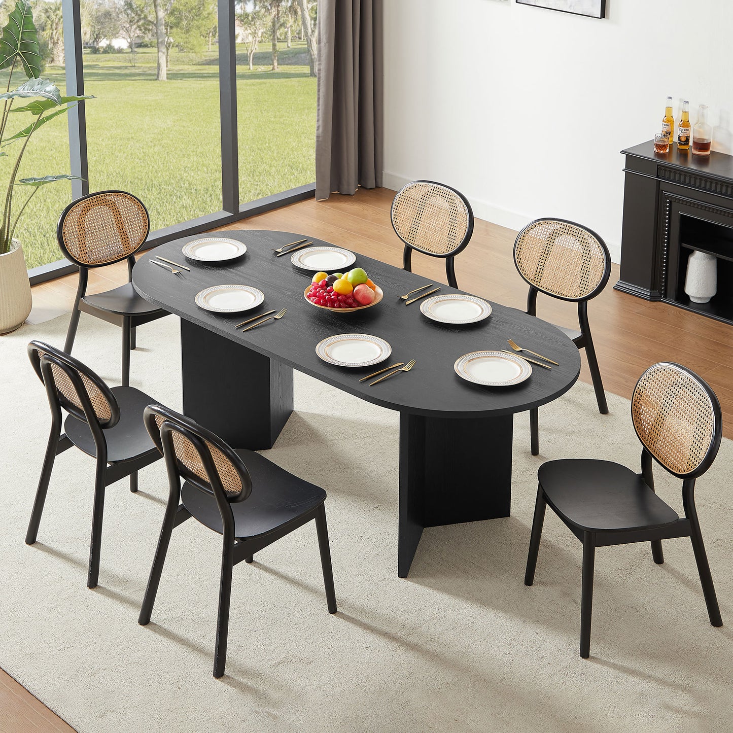 Black oval dining table with woven back chairs