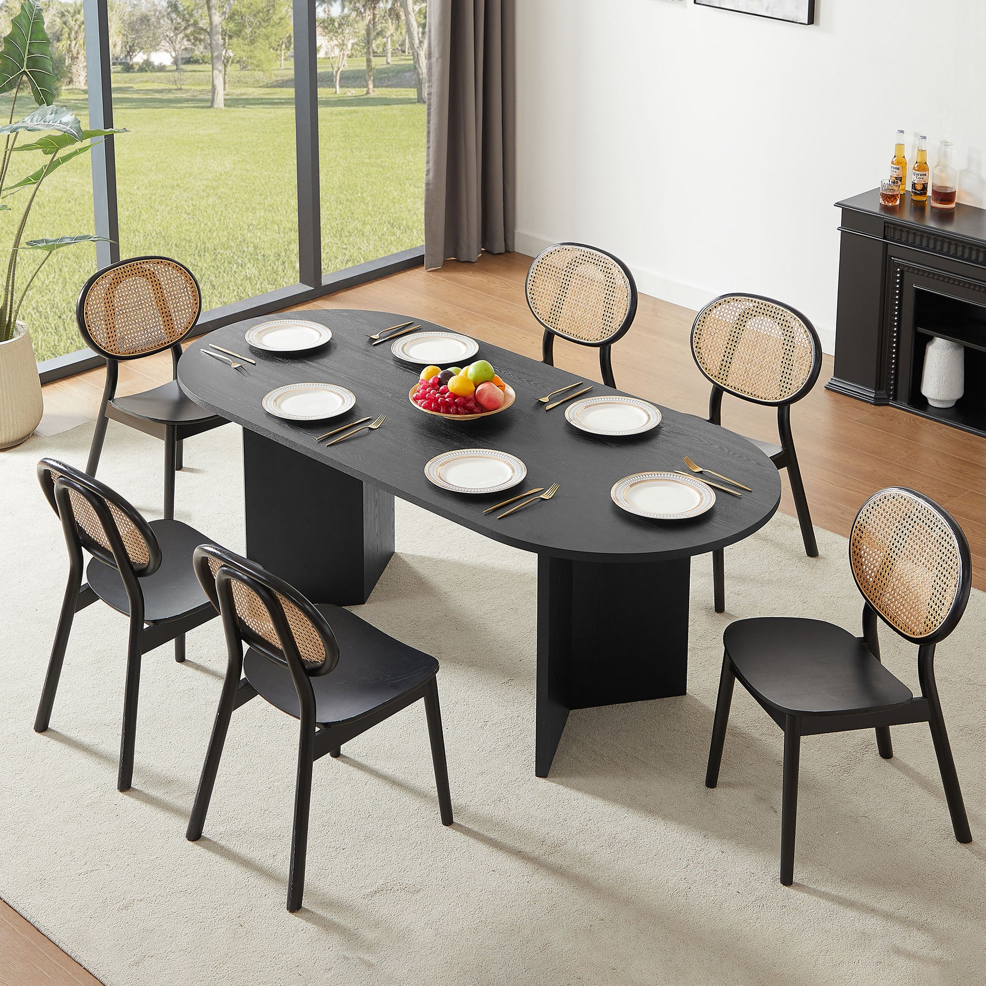Black oval dining table with woven back chairs