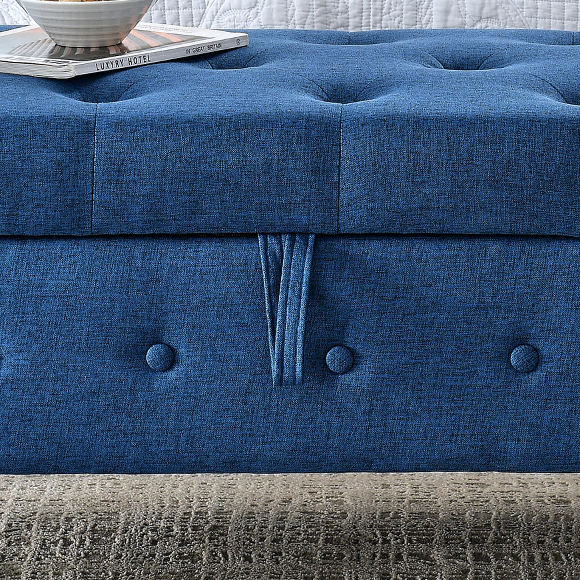 Deep blue linen tufted ottoman with decorative button detail