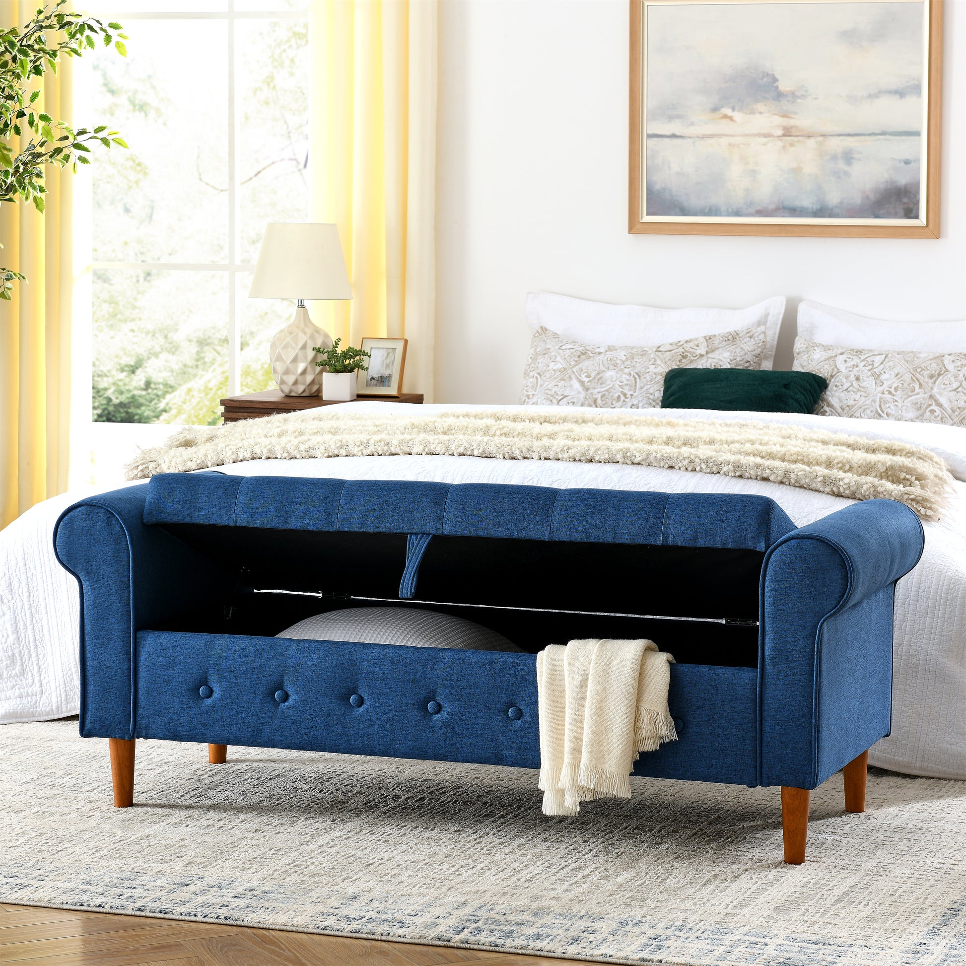 Blue fabric storage bench with tufted details and wooden legs