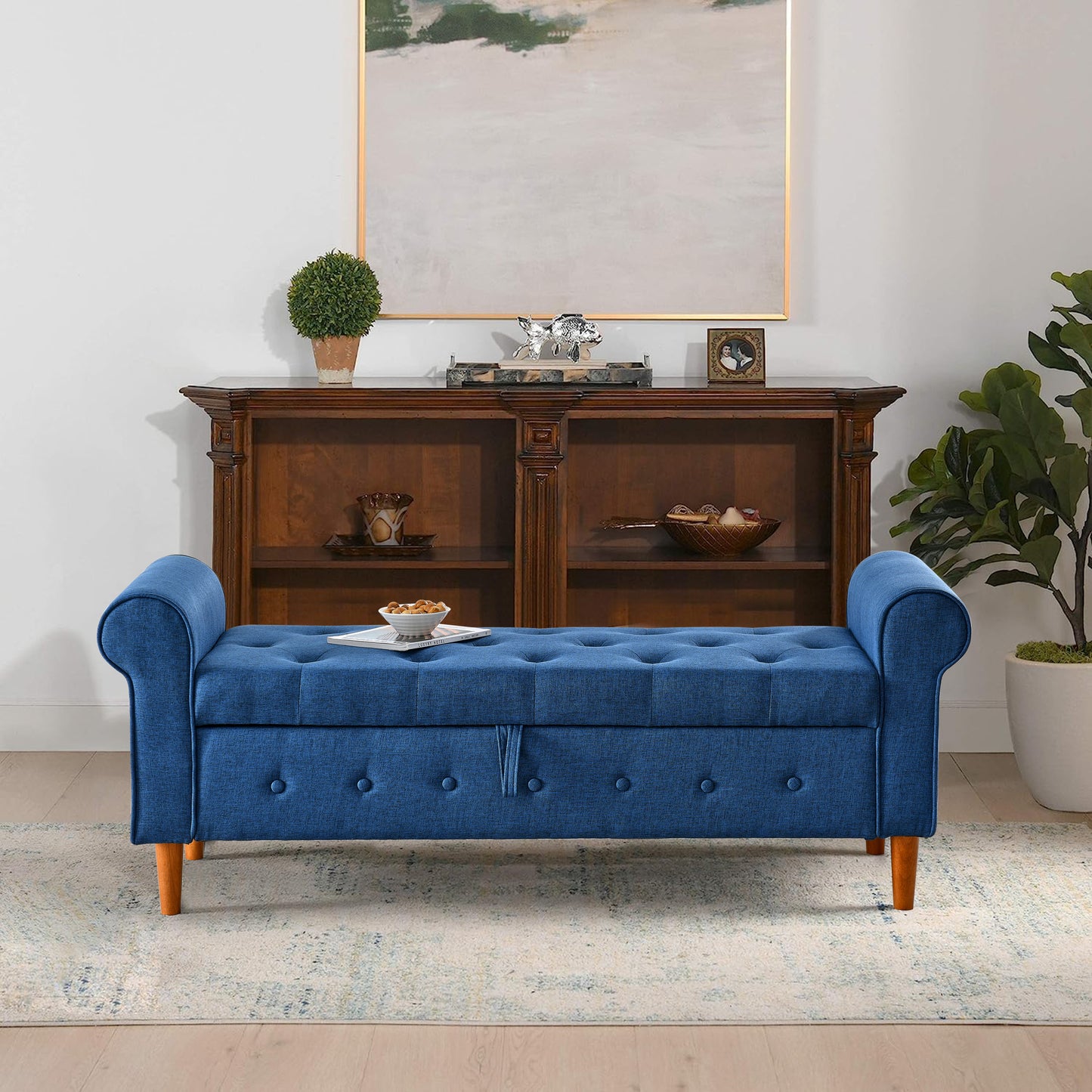 Blue upholstered storage bench with tufted detailing and wooden legs