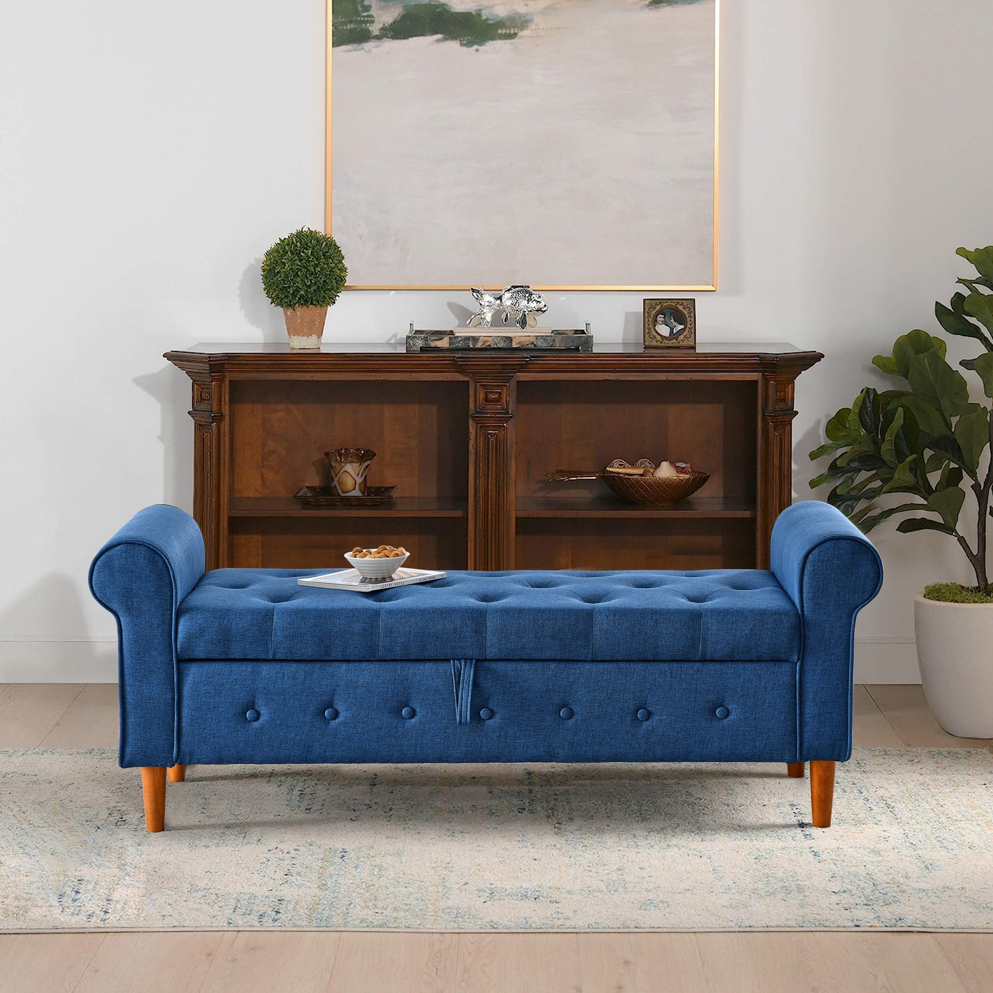 Blue upholstered storage bench with tufted detailing and wooden legs