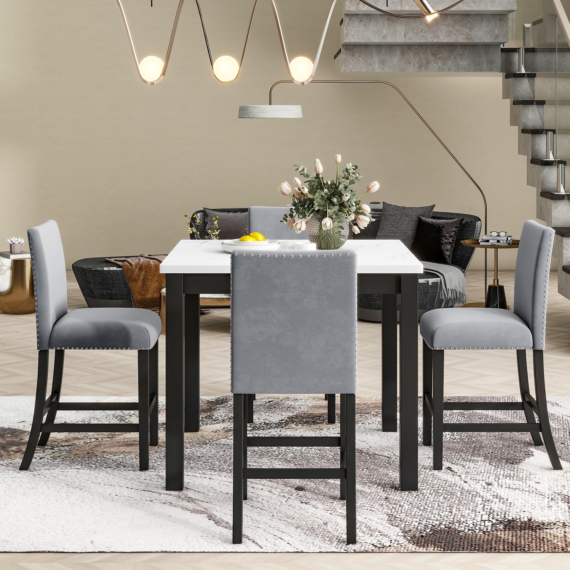 Grey velvet counter stool with silver nailhead trim and dark wood legs