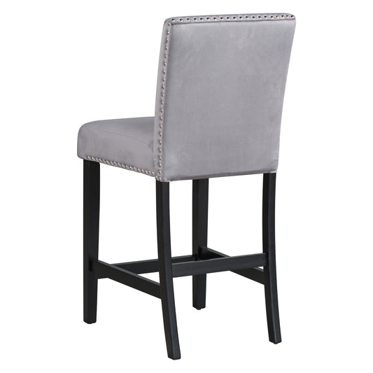 Gray velvet bar stool with studded trim and dark wood legs