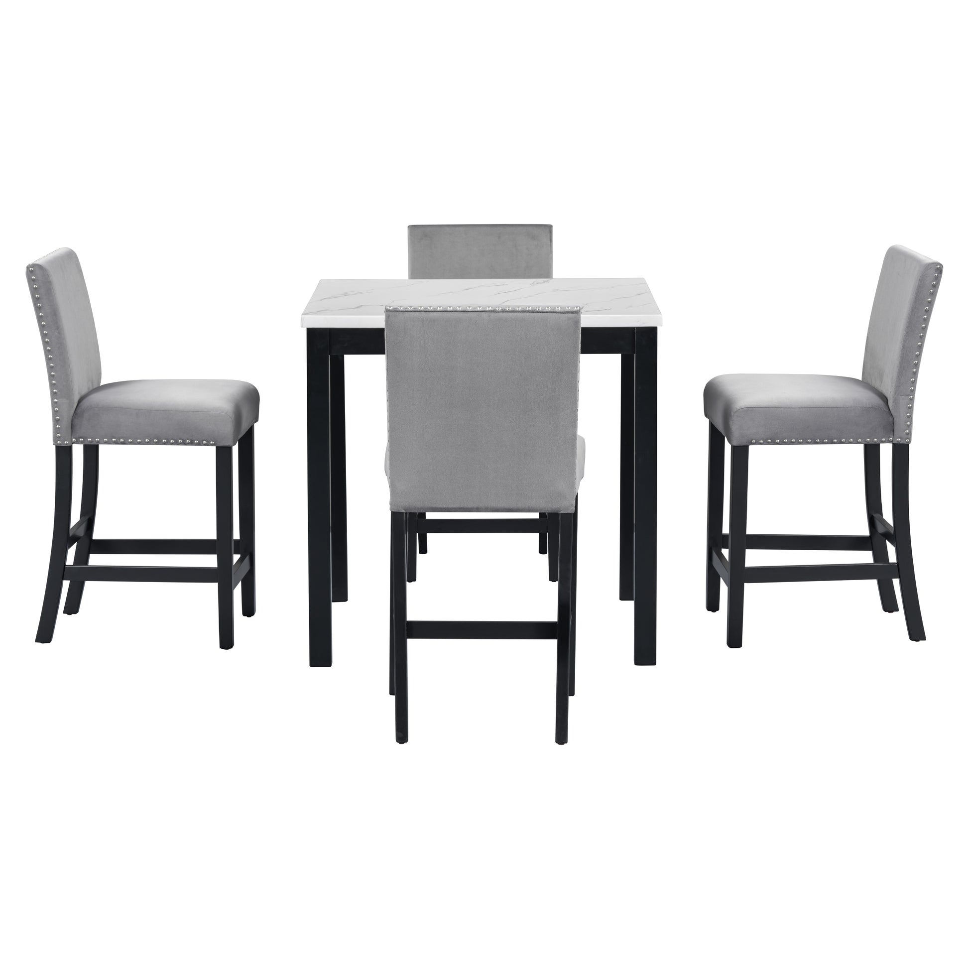 Grey velvet bar stools with silver nailhead trim surround a marbletop bar height table