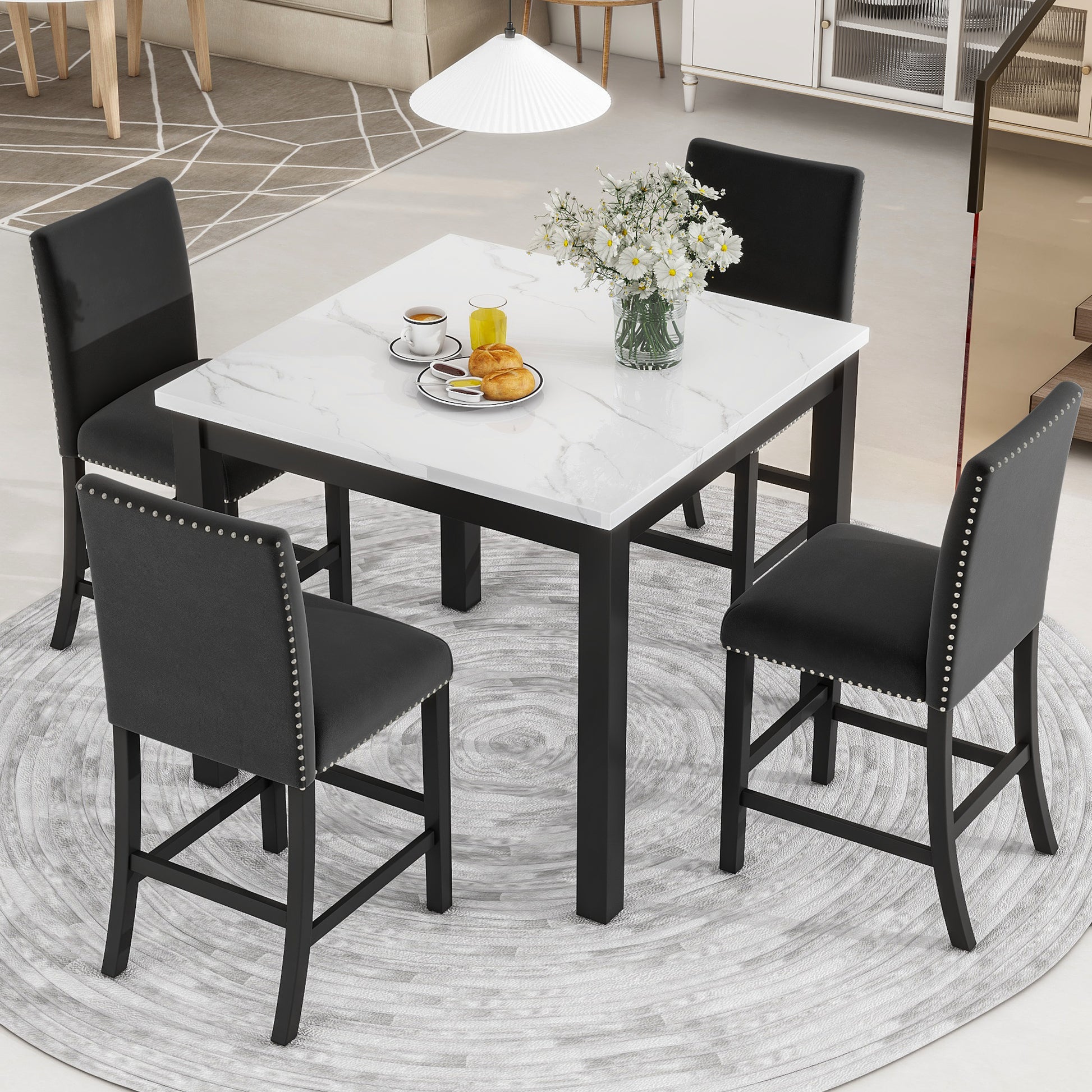 Black upholstered bar stool with silver nailhead trim and dark wood legs