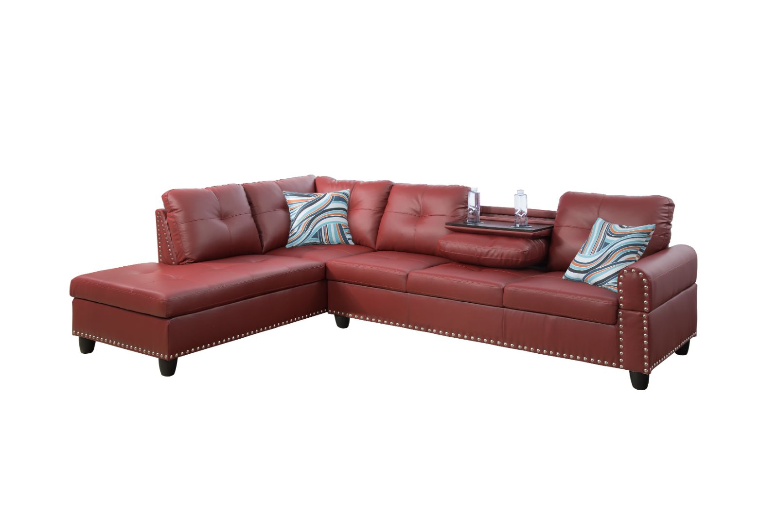 Red faux leather sectional sofa with tufted cushions and silver nailhead trim