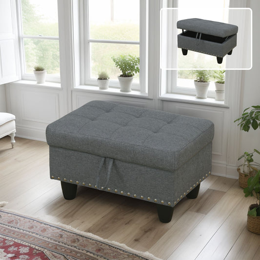 Gray tufted storage ottoman with silver nailhead trim and dark wooden legs