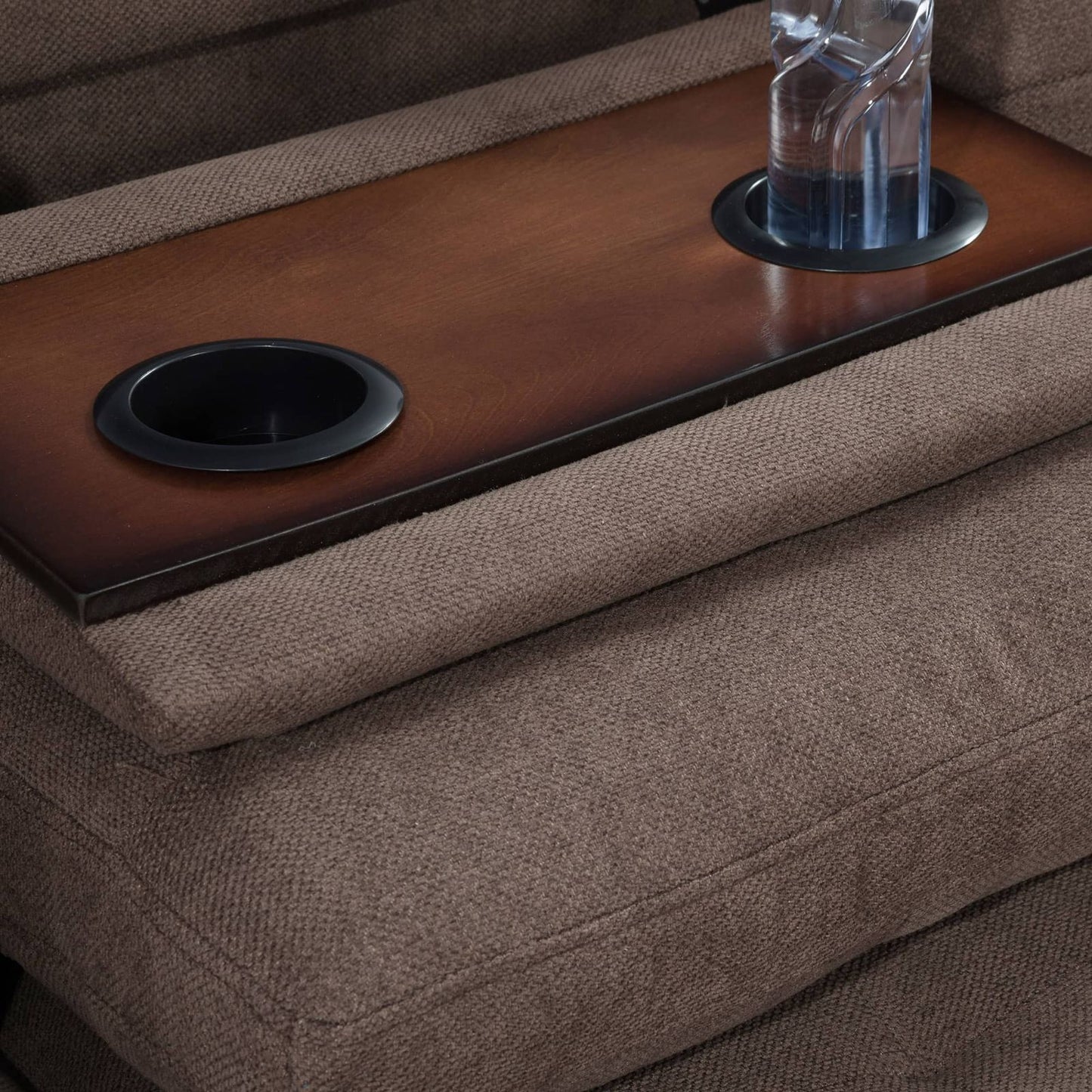 Brown microfiber recliner with wooden center console and cup holders
