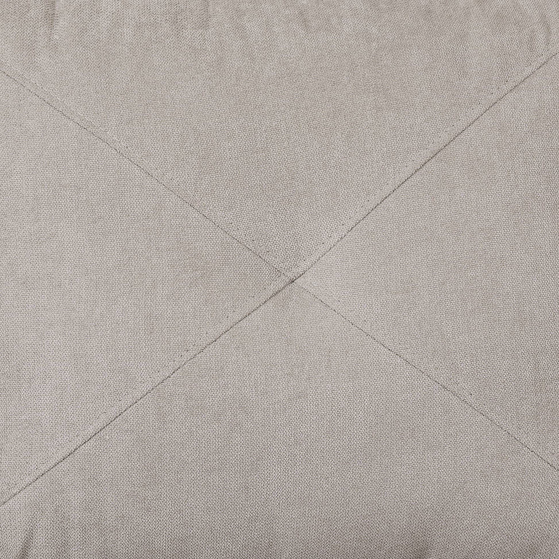 Closeup of beige woven fabric with diamond stitching