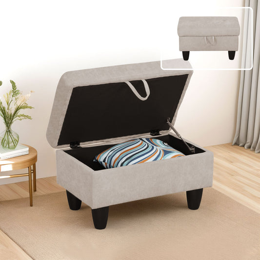 Light beige storage ottoman with tufted lid and dark legs open showing pillow storage