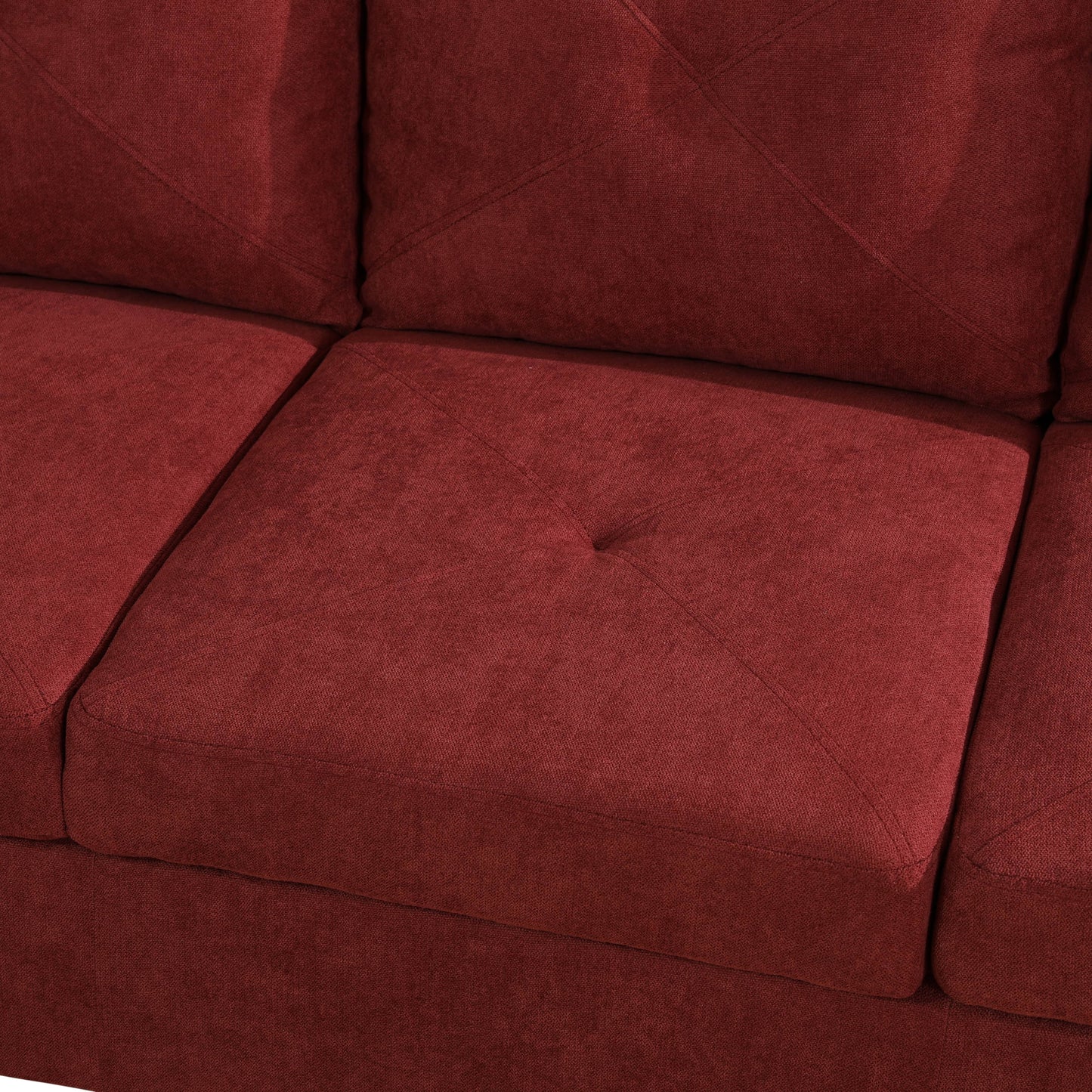 Close up of tufted deep red fabric sofa cushion