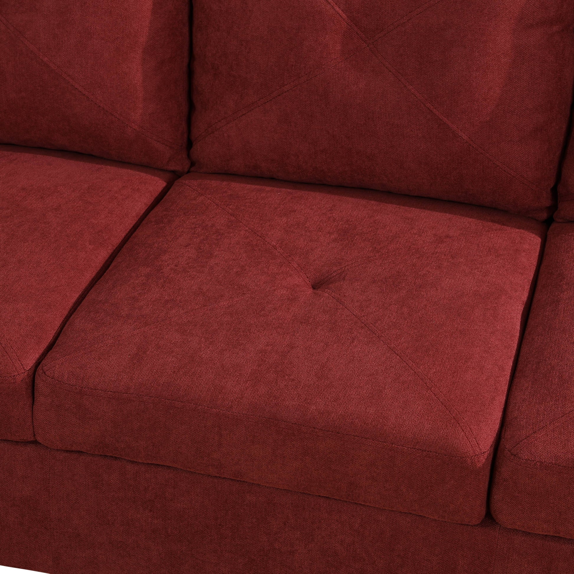Close up of tufted deep red fabric sofa cushion