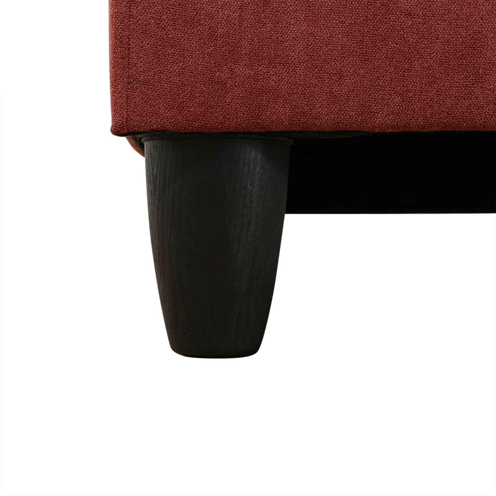 Textured rustred fabric on a dark tapered furniture leg