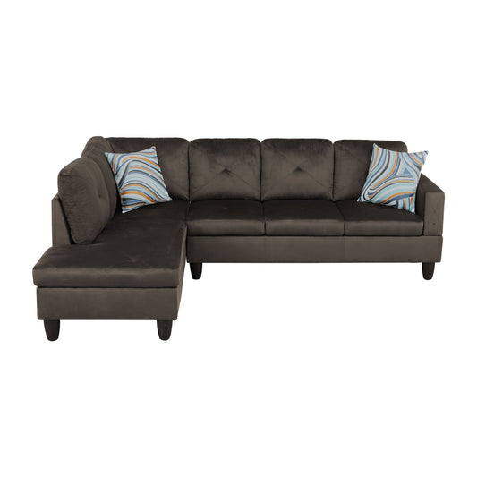 Dark gray velvet sectional sofa with tufted cushions and a decorative pillow