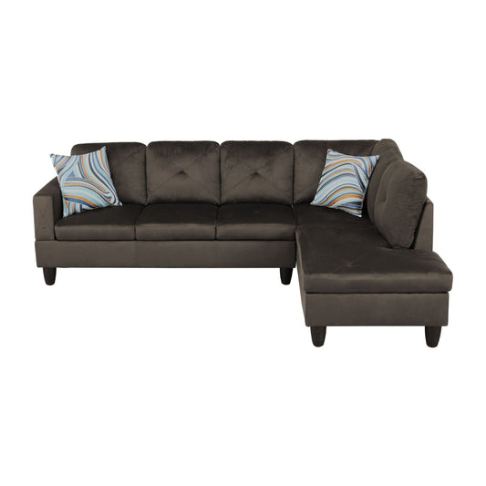 Dark brown velvet sectional sofa with tufted back cushions and patterned pillows