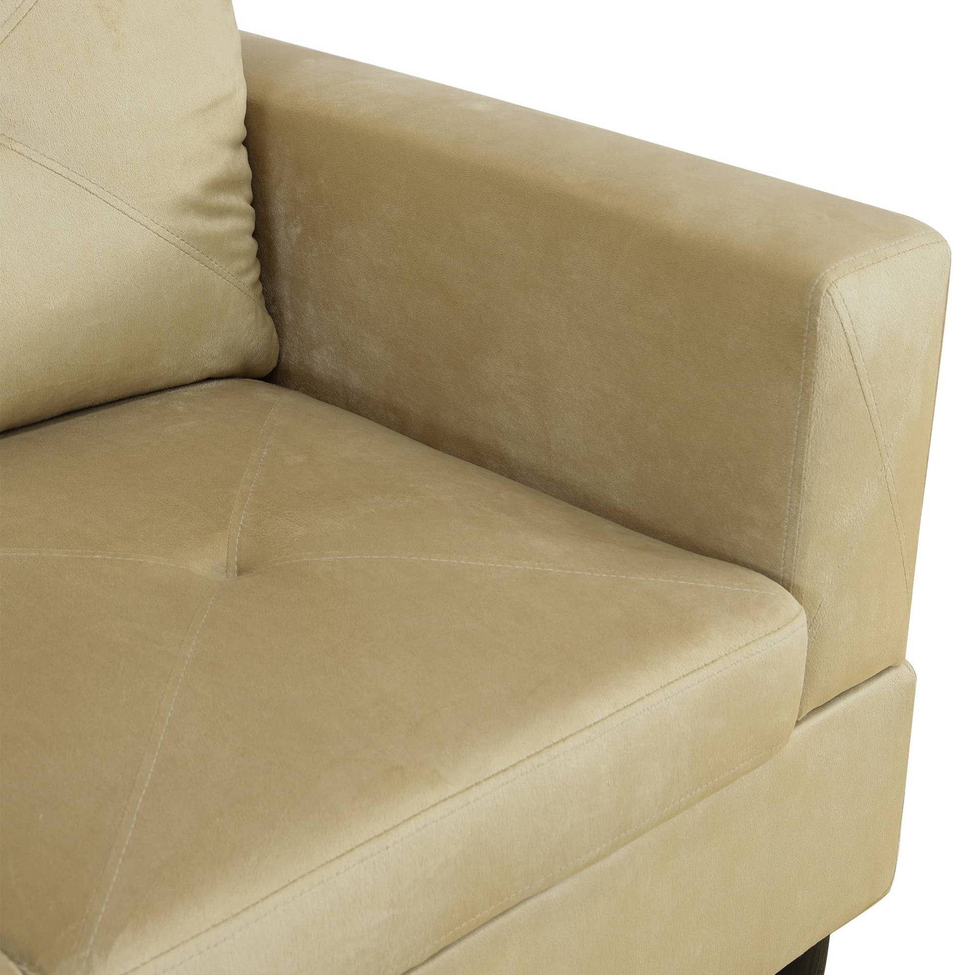 Beige velvet armchair closeup with tufted seat and diamond stitching