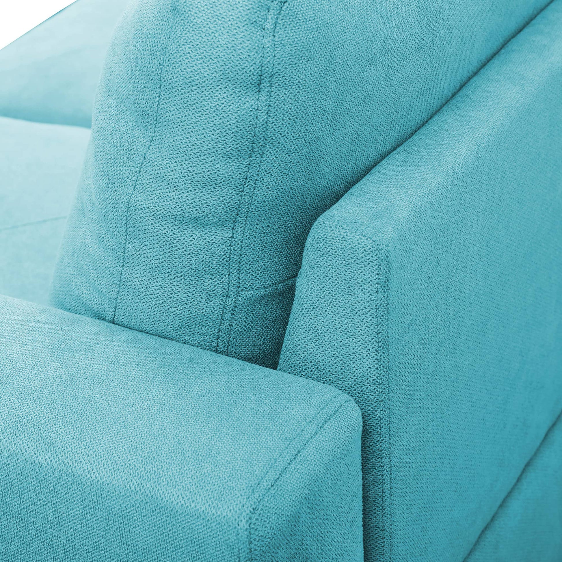 Closeup of a textured teal fabric couch armrest