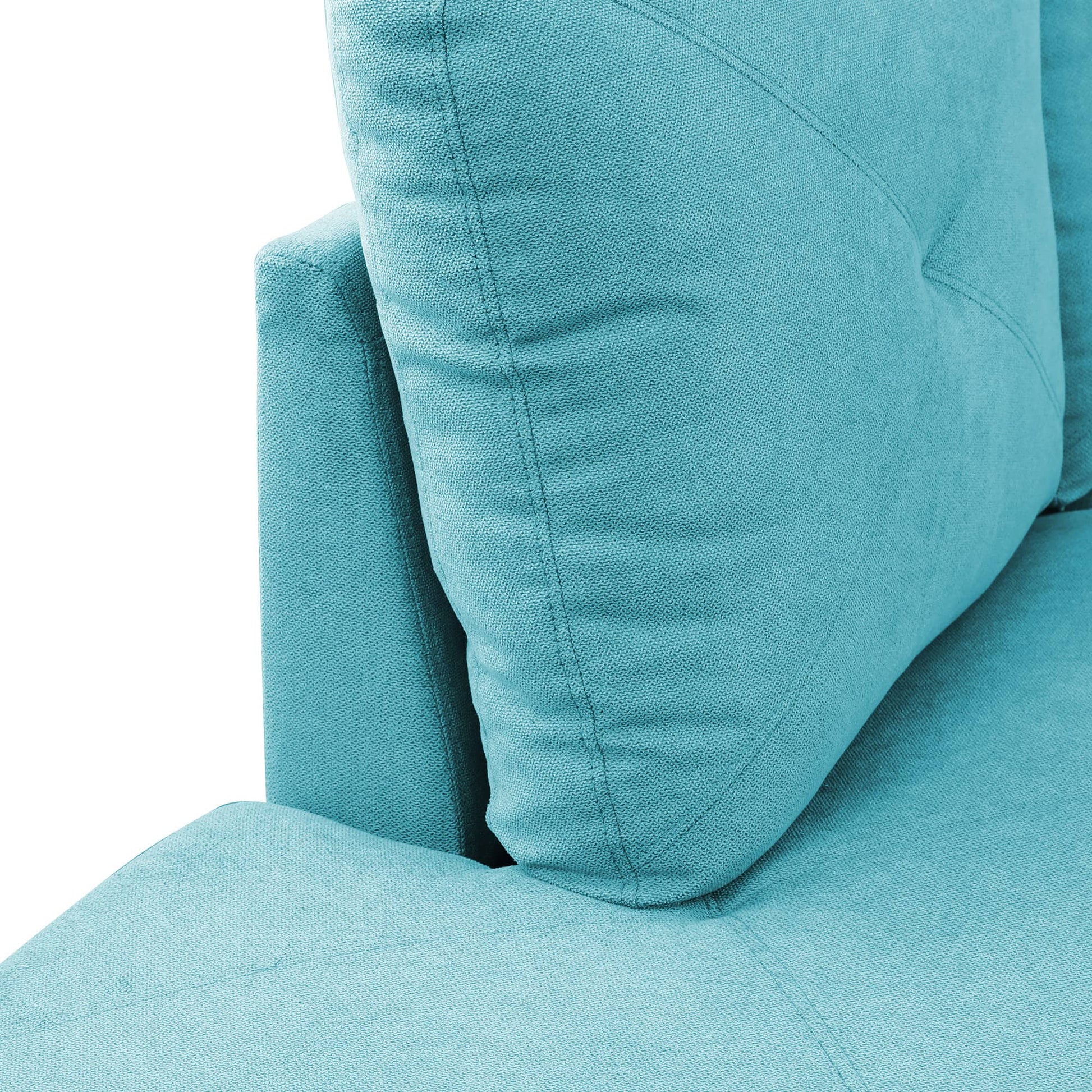Teal fabric sofa closeup with textured cushions and stitching