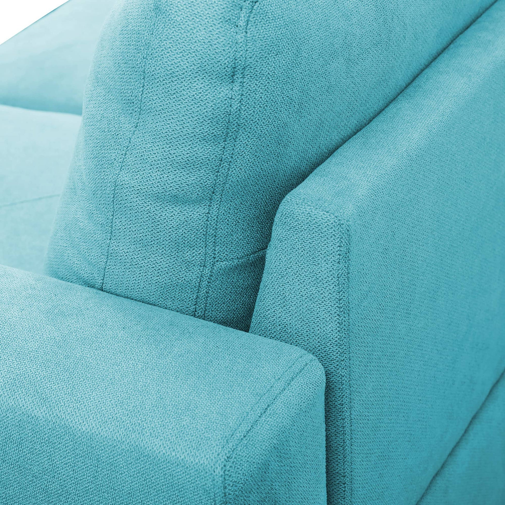 Teal upholstered armchair armrest and cushion detail
