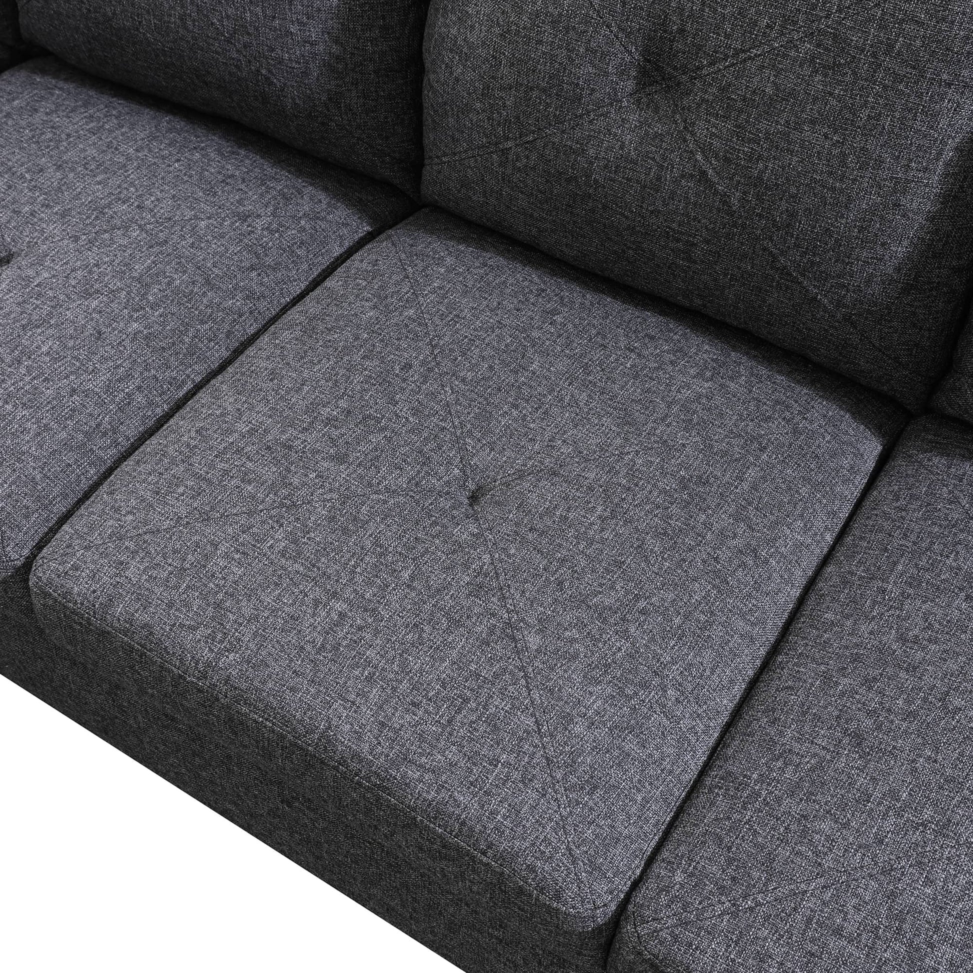 Dark grey fabric sofa detail with tufted cushions