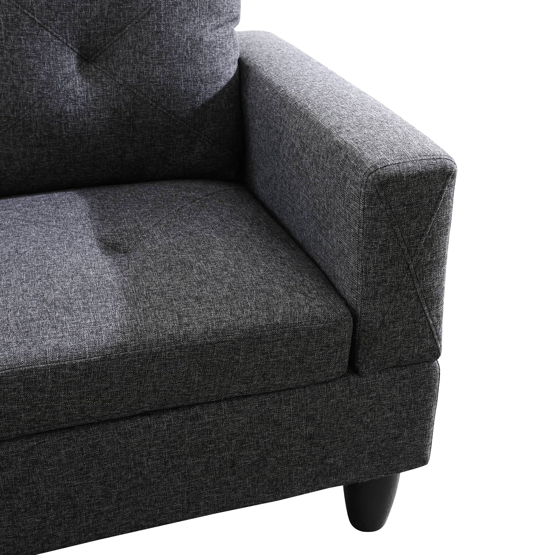 Dark gray fabric sofa with tufted backrest and modern armrest