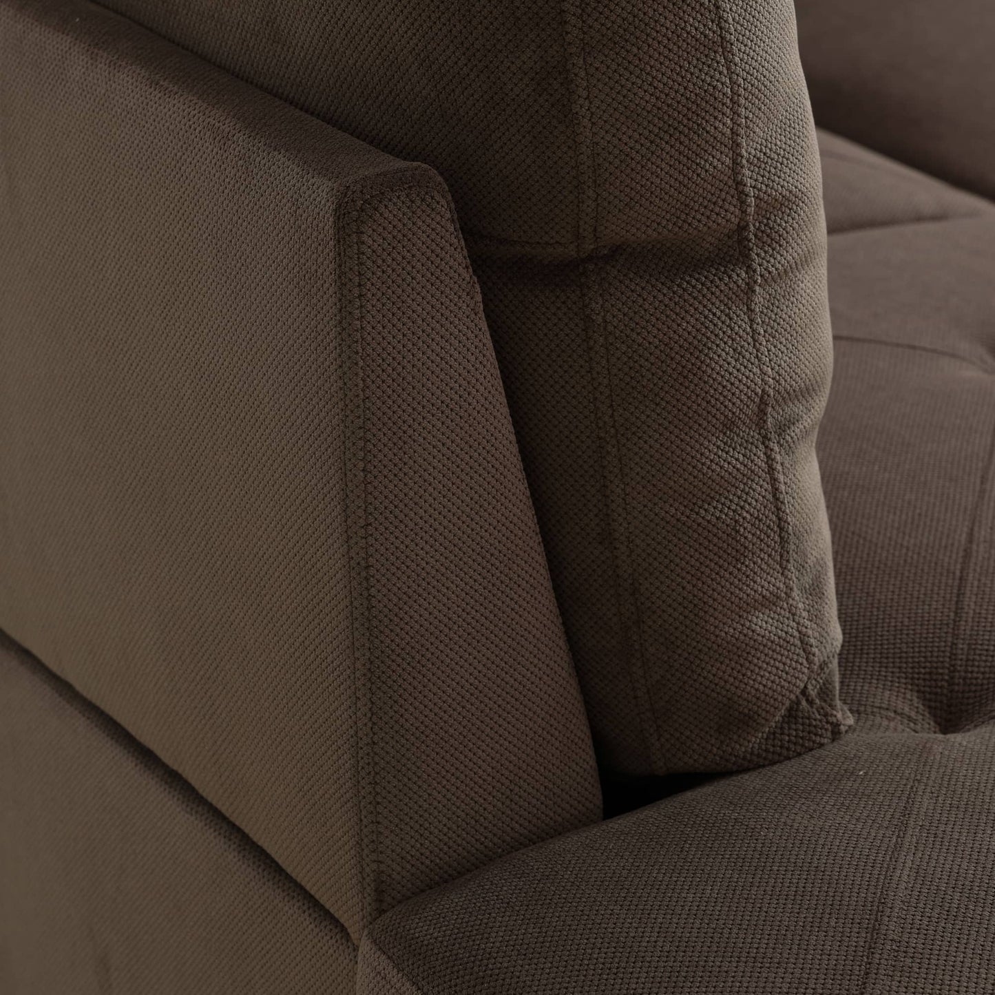 Brown textured fabric sofa armrest and cushion detail