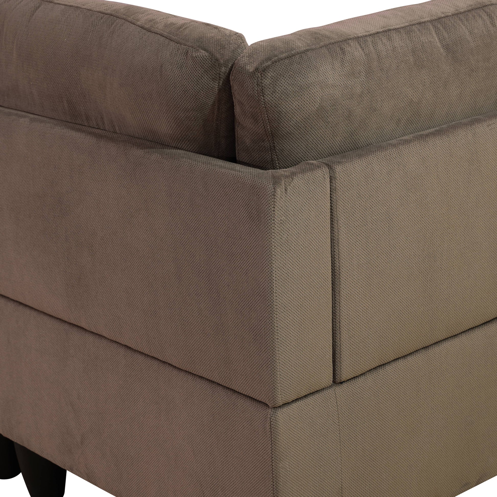 Brown fabric sectional sofa corner detail with textured weave