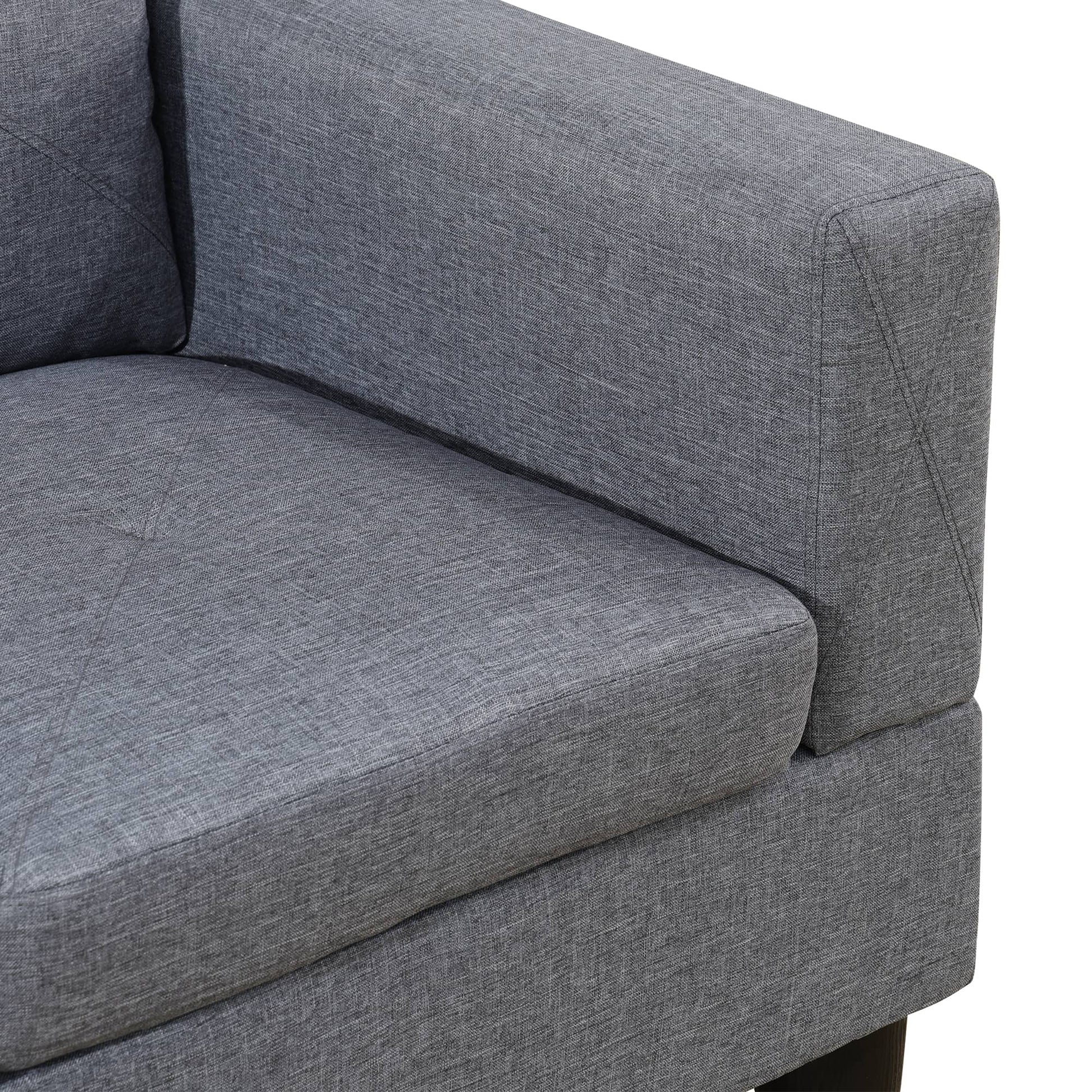 Closeup of a grey fabric sofa armrest with textured weave detail