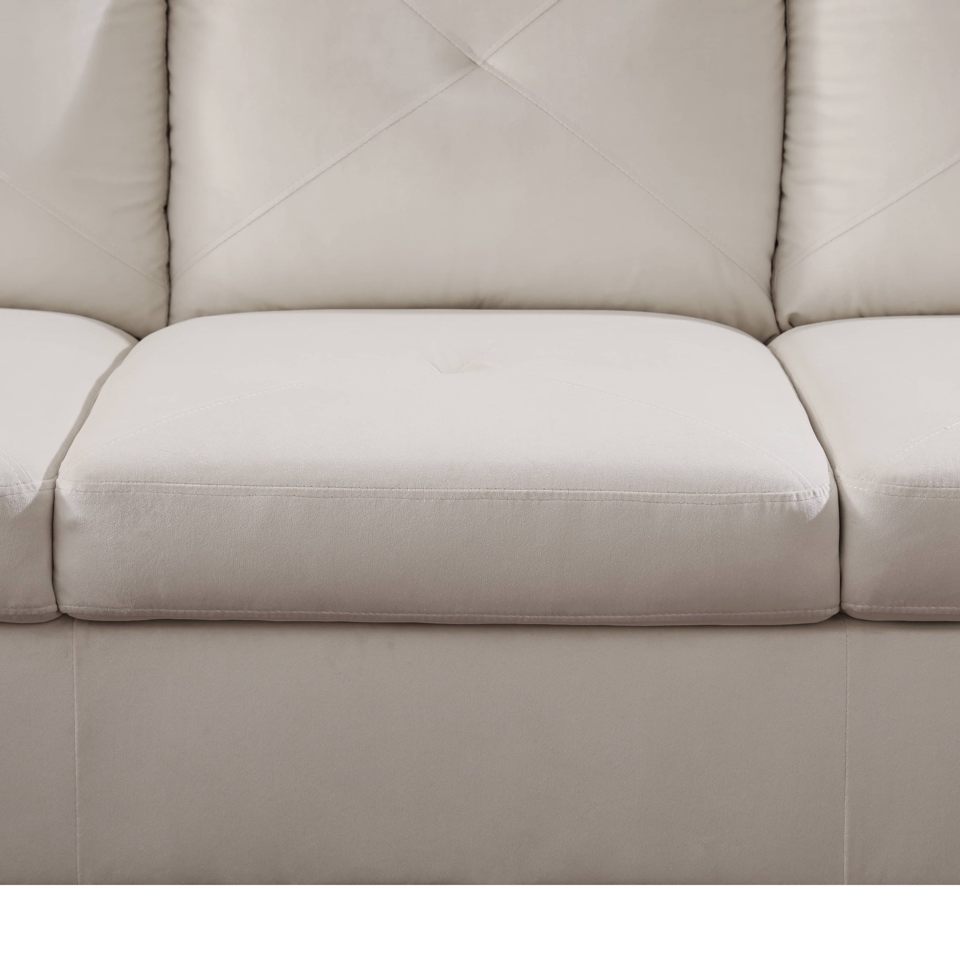 Cream leather sectional sofa with diamond tufting on back cushions and piped seams