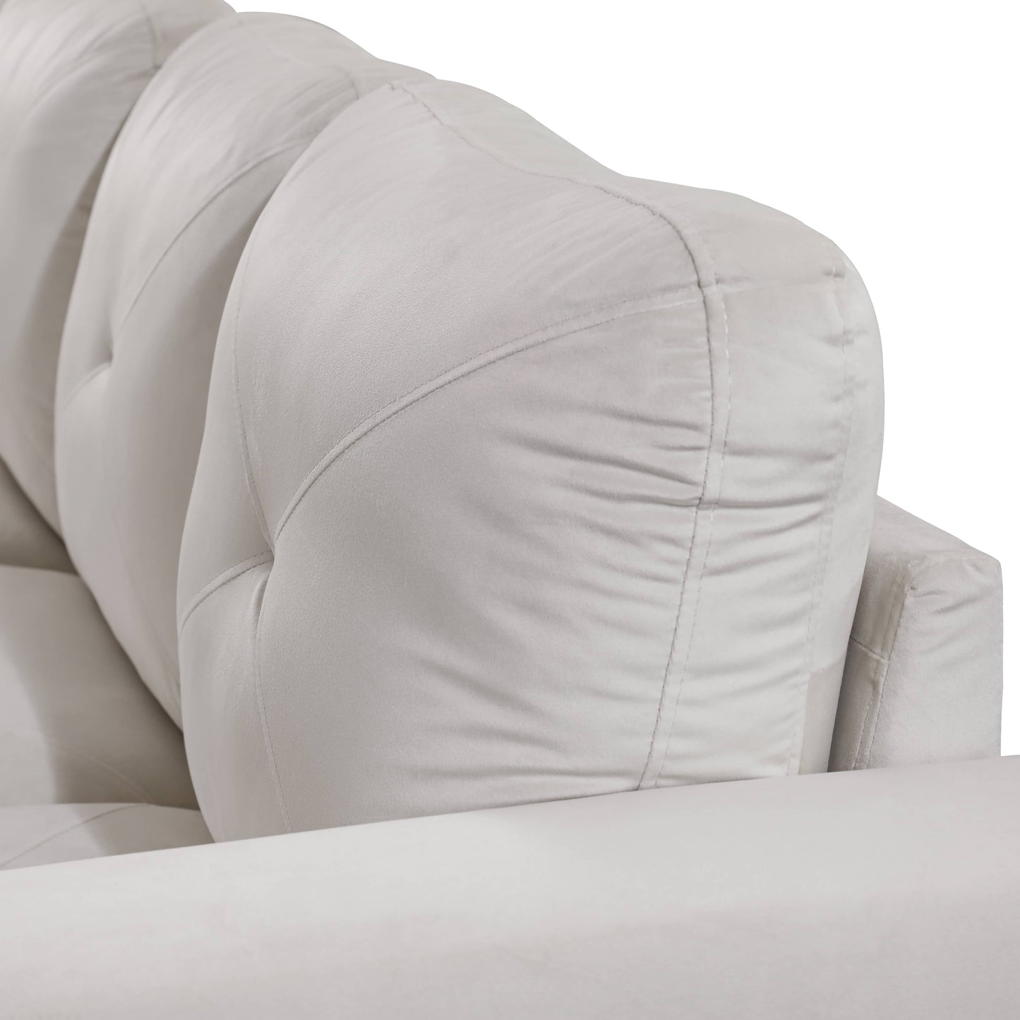 Light gray tufted sofa backrest with plush cushions