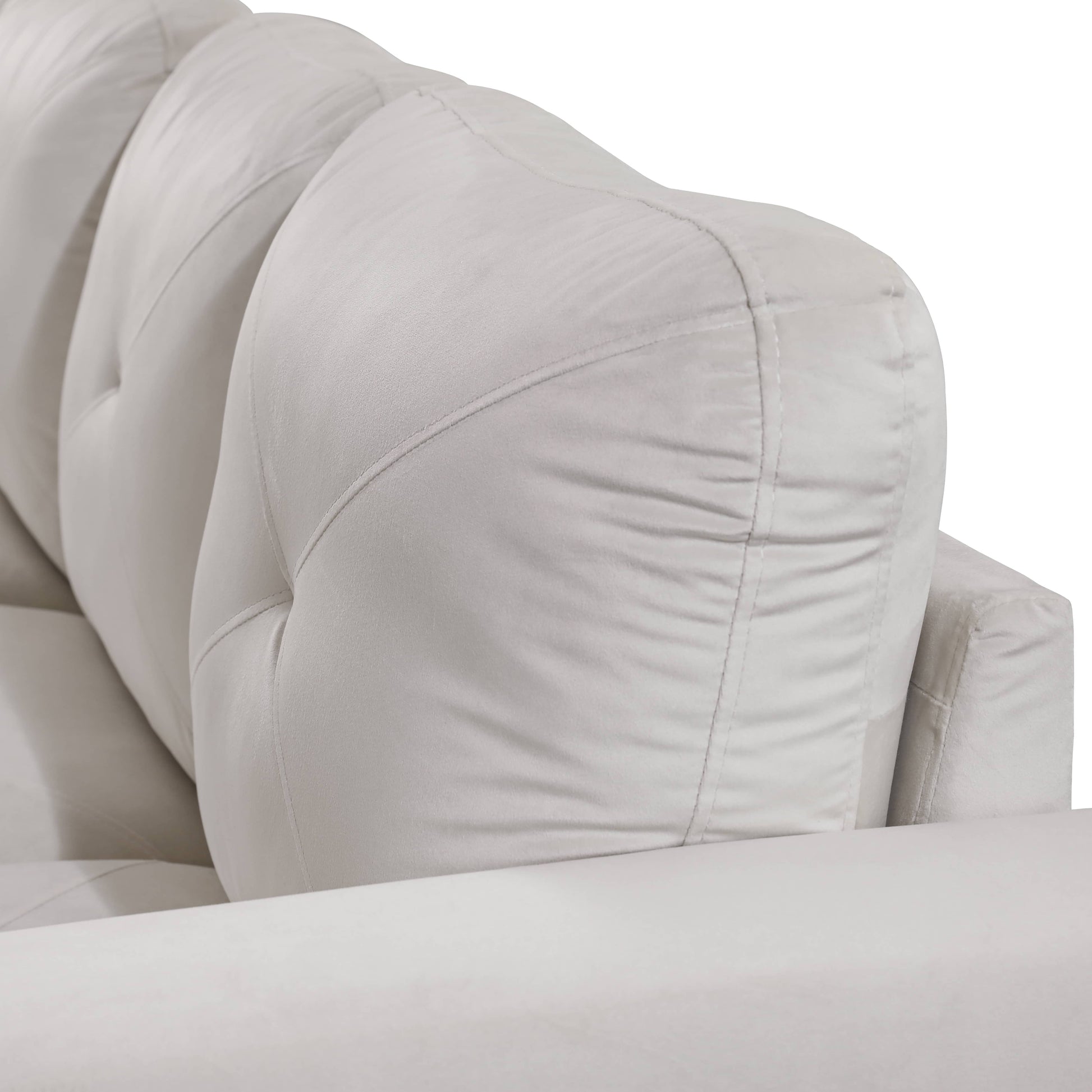 Light gray tufted sofa backrest with plush cushions