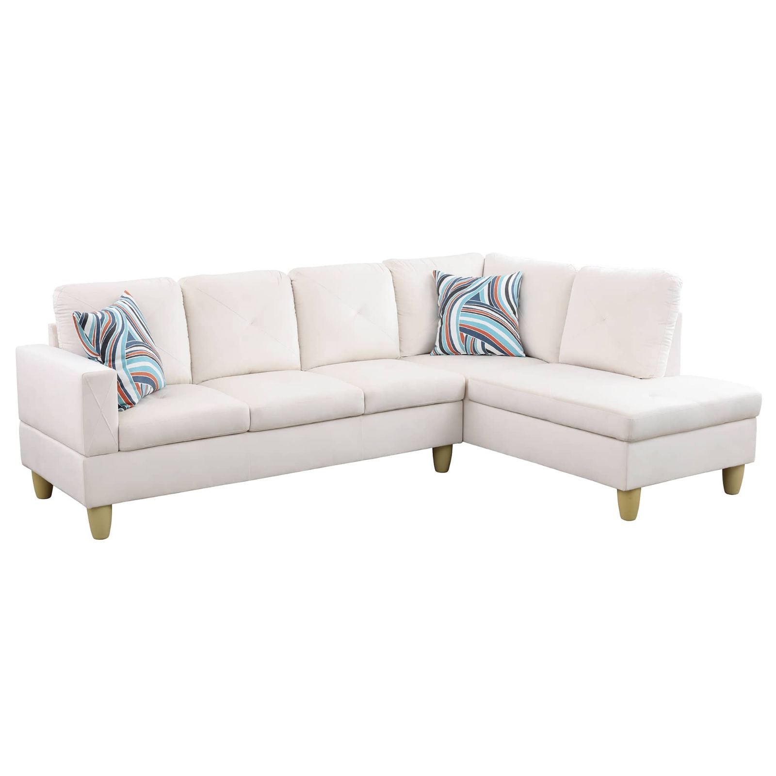 Cream sectional sofa with abstract patterned pillows and gold legs