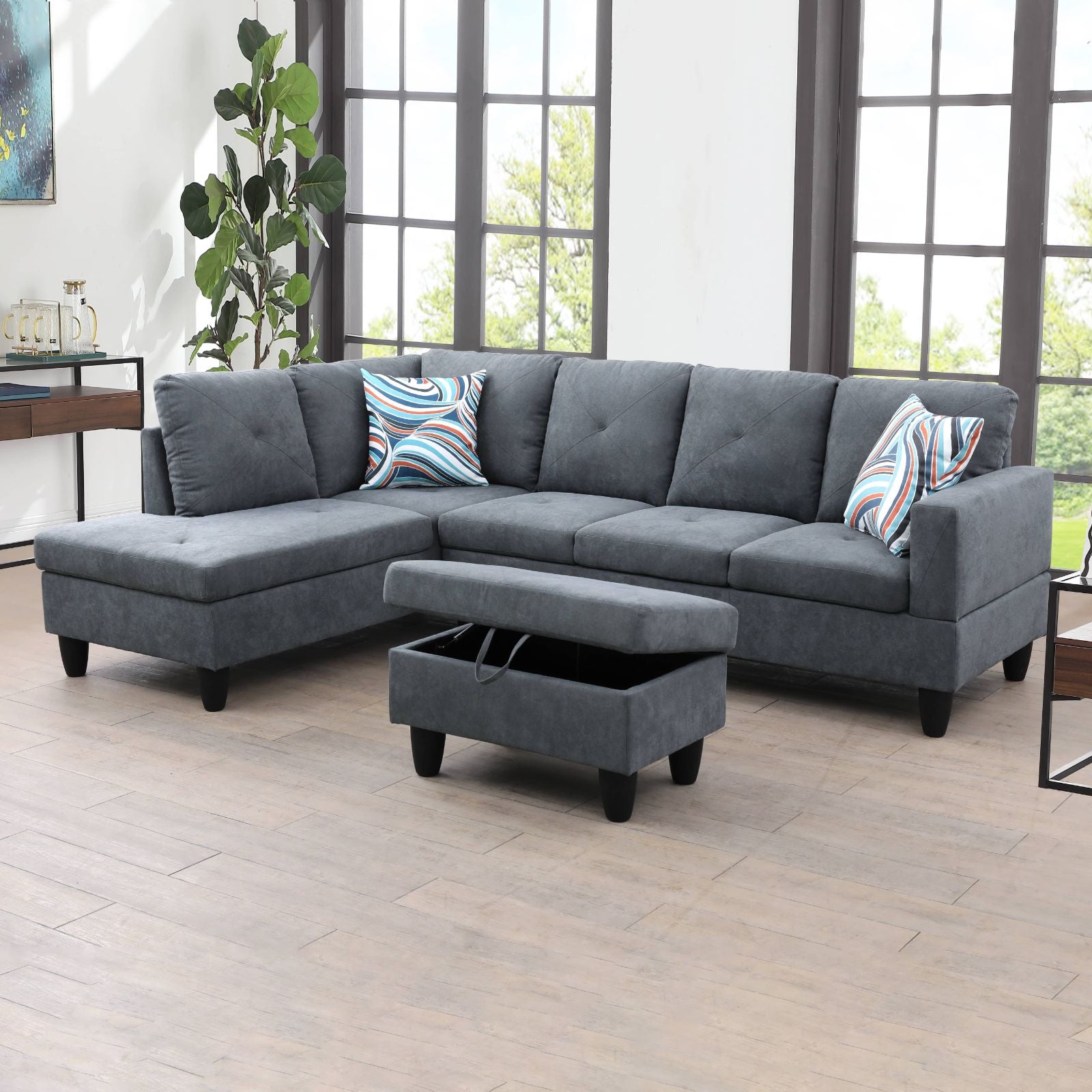 Dark gray fabric sectional sofa with tufted cushions and storage ottoman