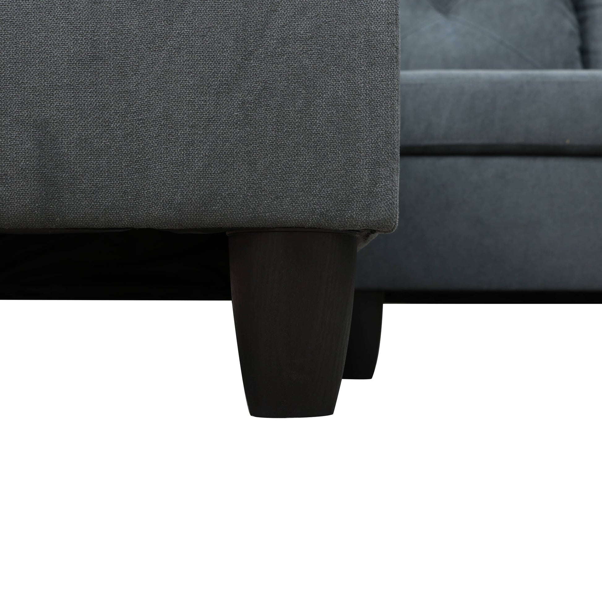 Closeup of dark gray textured fabric on the side of a modern sofa