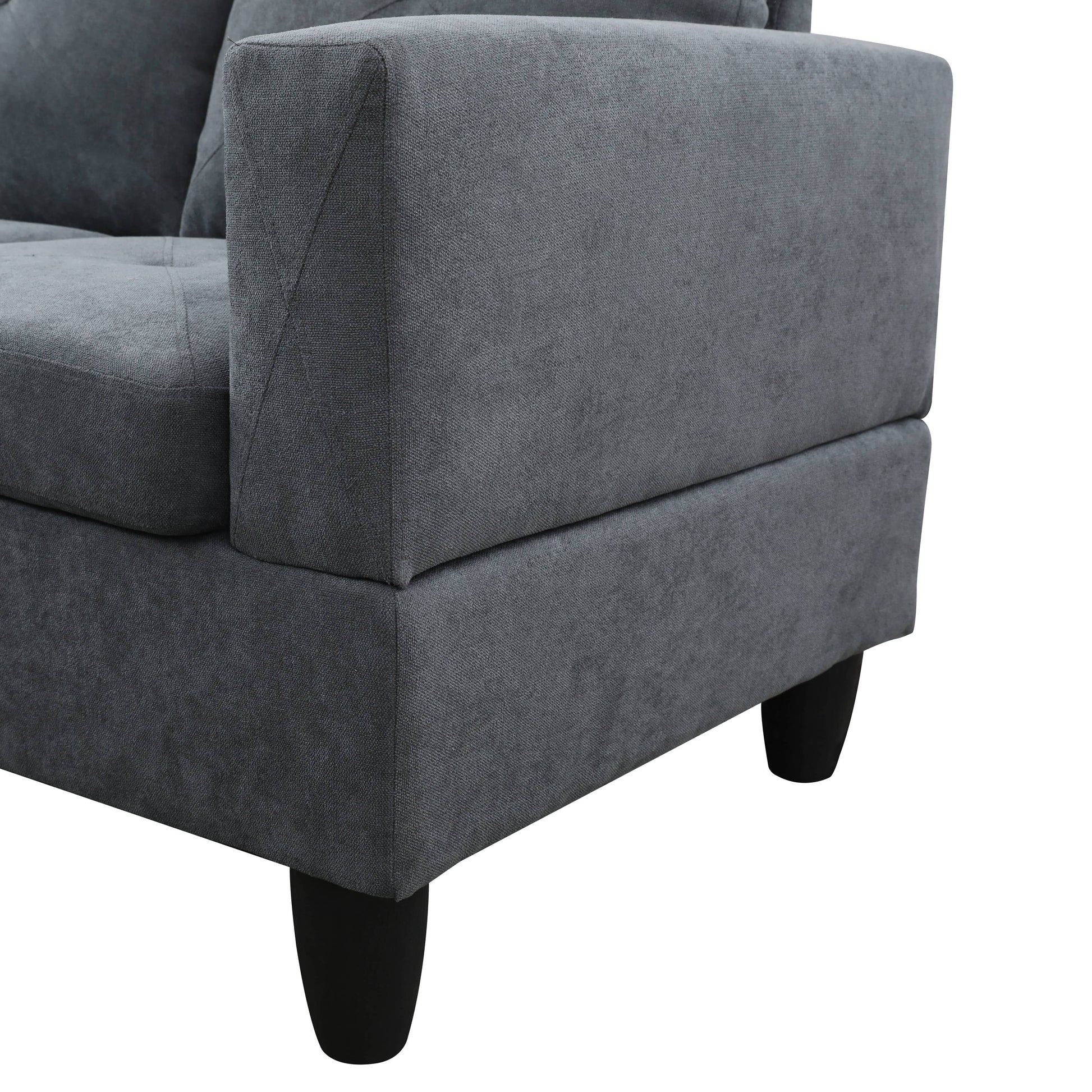 Closeup of dark grey textured fabric sofa arm