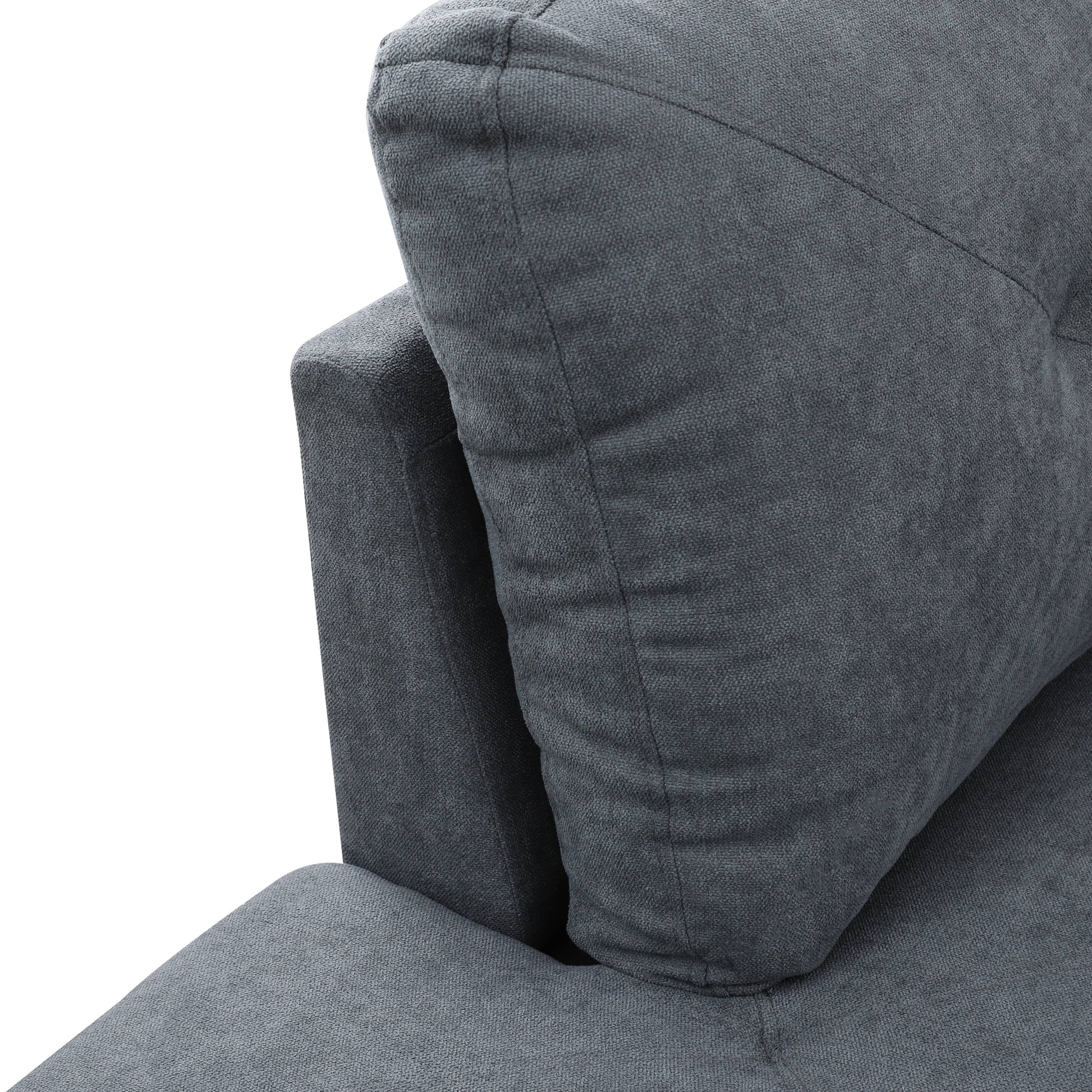 Closeup of grey textured fabric sofa with plush cushion